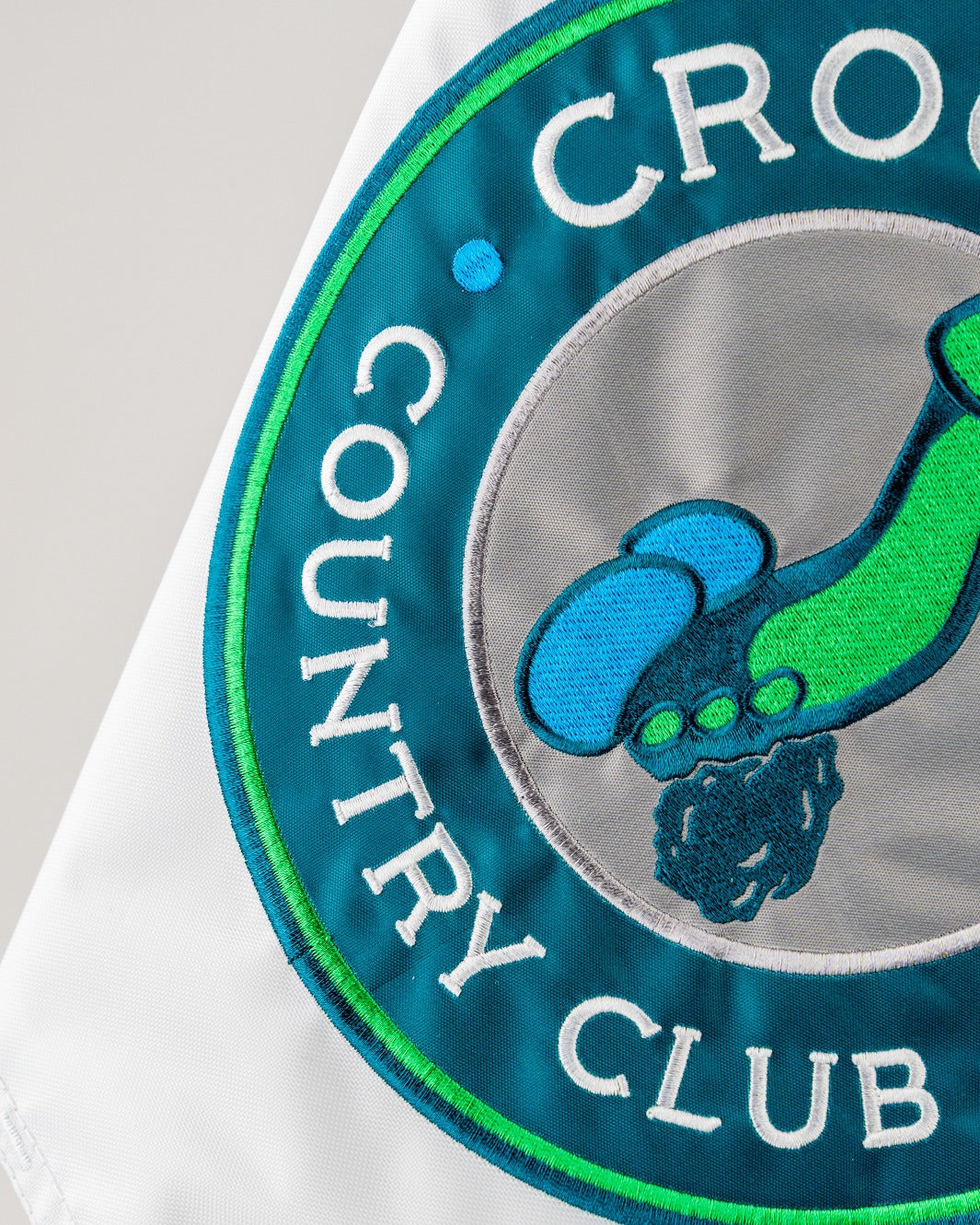 Bold golf flag featuring a humorous design with a playful illustration and the text "Crooked Dick Country Club.