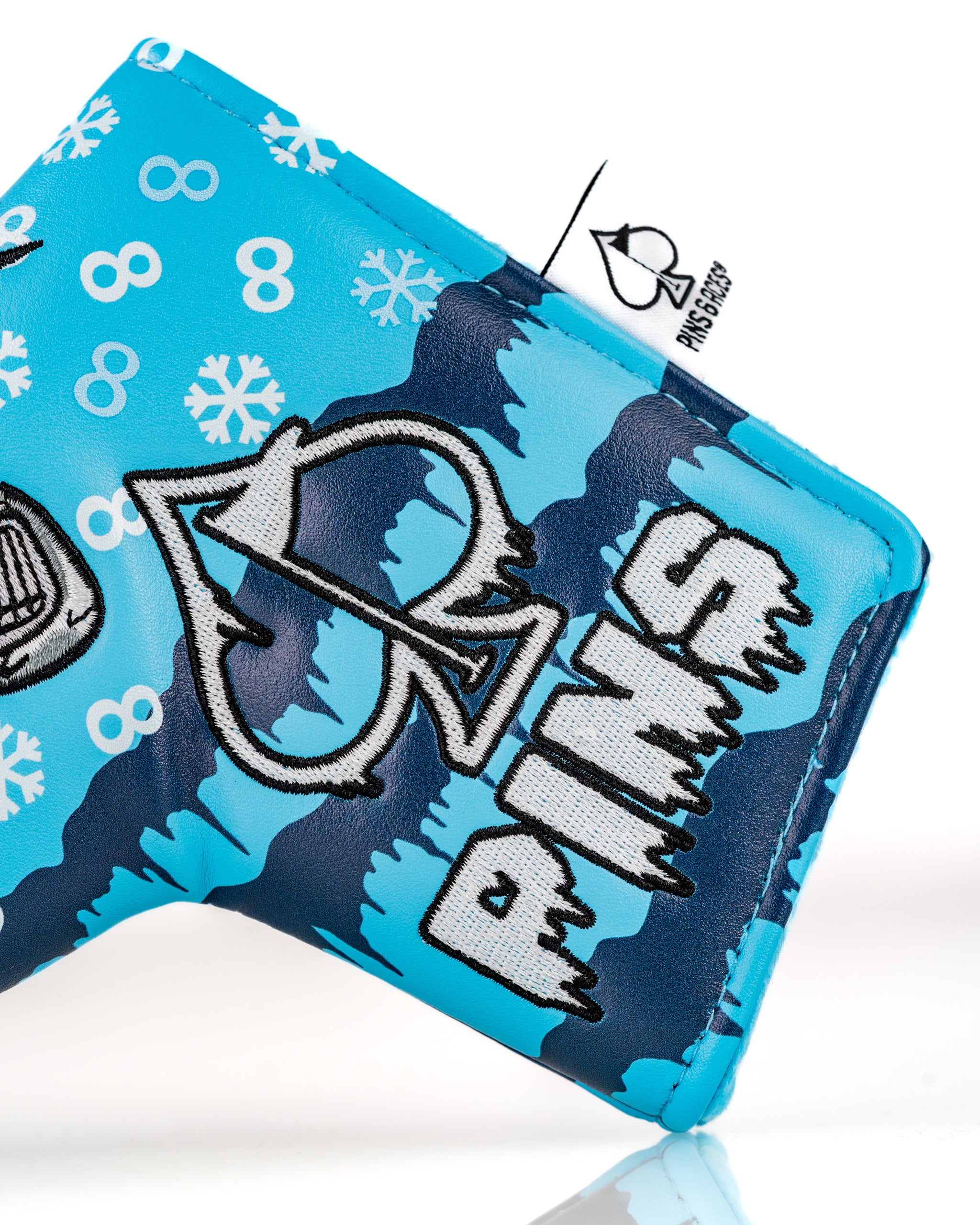 Bright blue blade putter cover featuring a snowman design and playful winter graphics, perfect for stylish golfers.