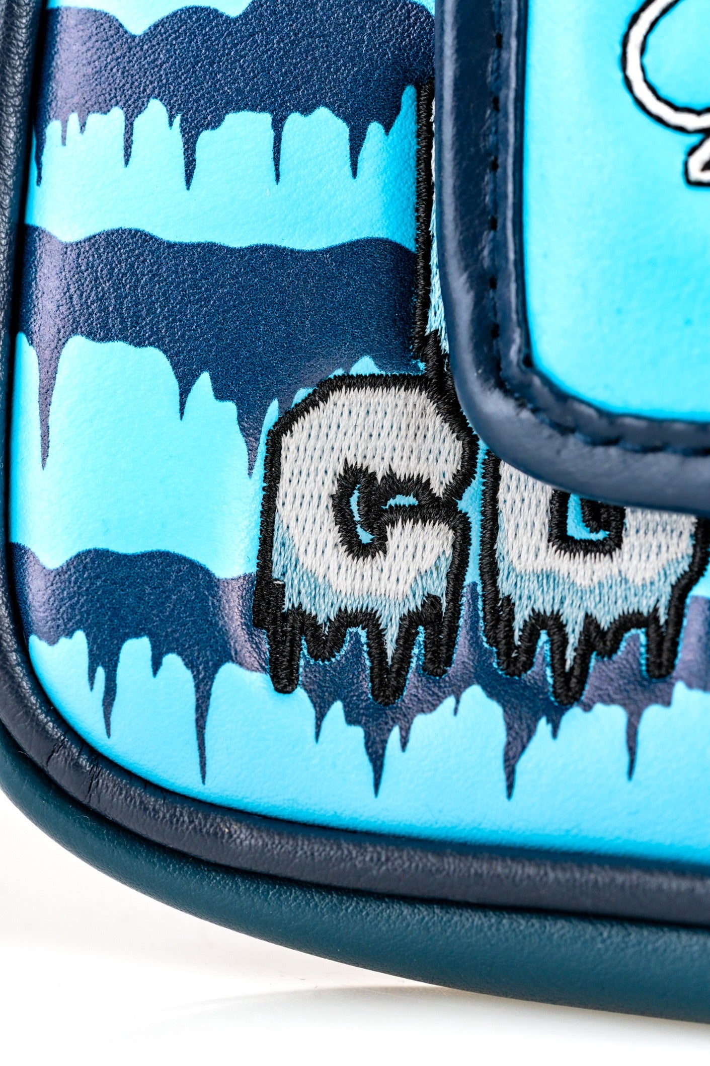 Snowman mallet cover featuring a blue and navy design with icy drip details and bold embroidered lettering.
