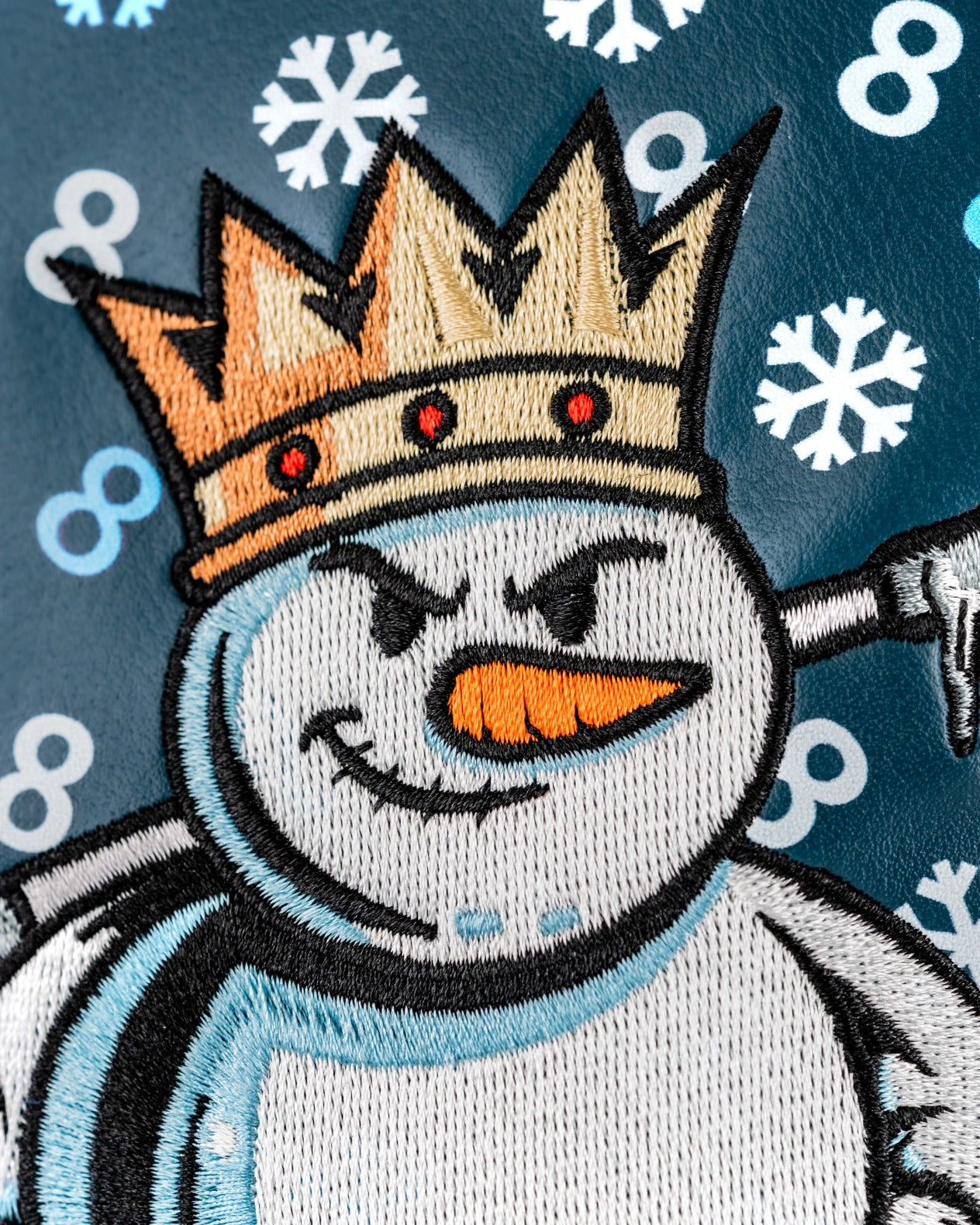 Snowman fairway cover featuring a crowned snowman with a mischievous expression against a snowflake background.