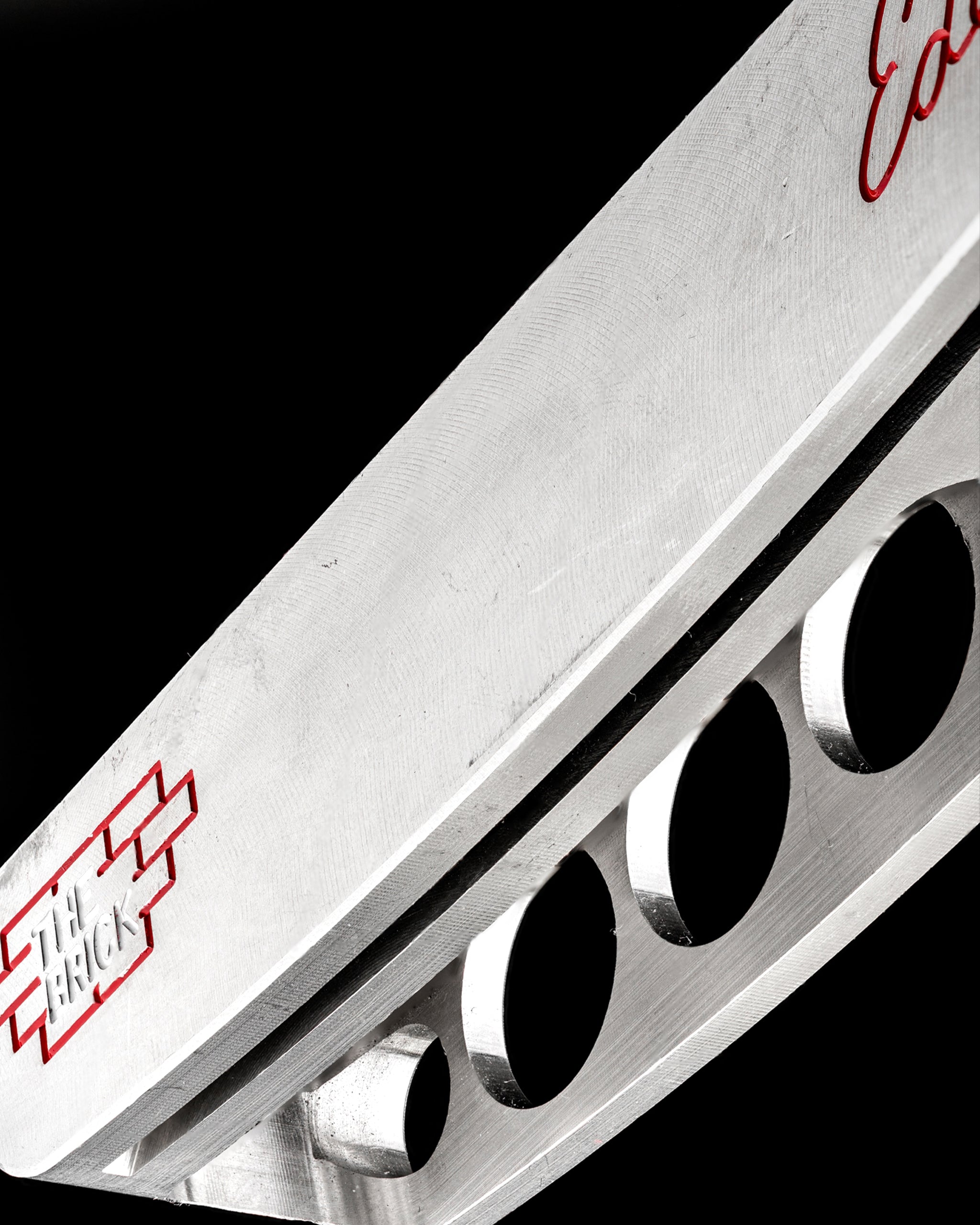 Close-up of The Brick blade putter by Edel Golf, showcasing its sleek design and precision-engineered face.