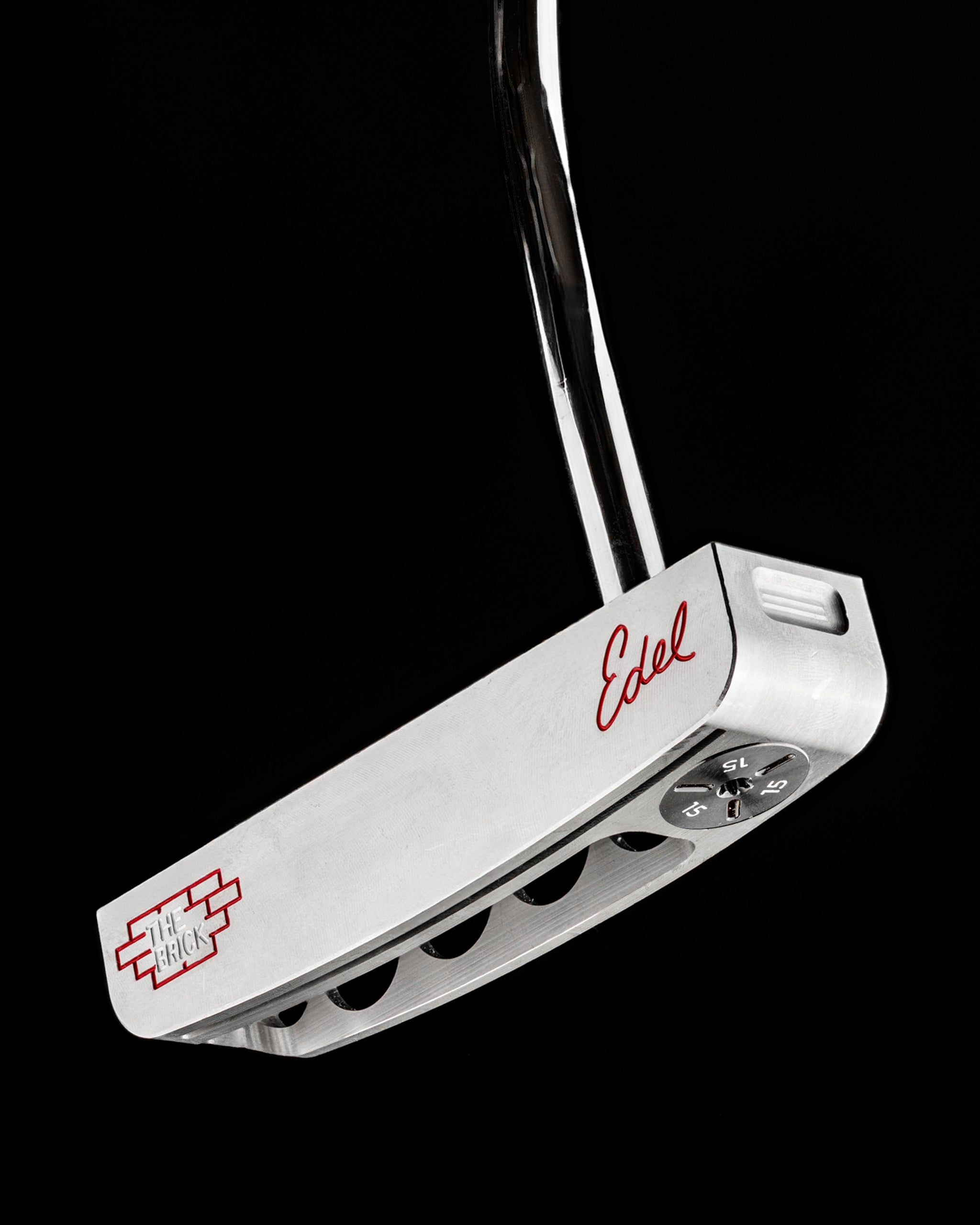 Sleek Edel Golf Blade Putter named The Brick, featuring a polished silver finish and adjustable weight system for precision.