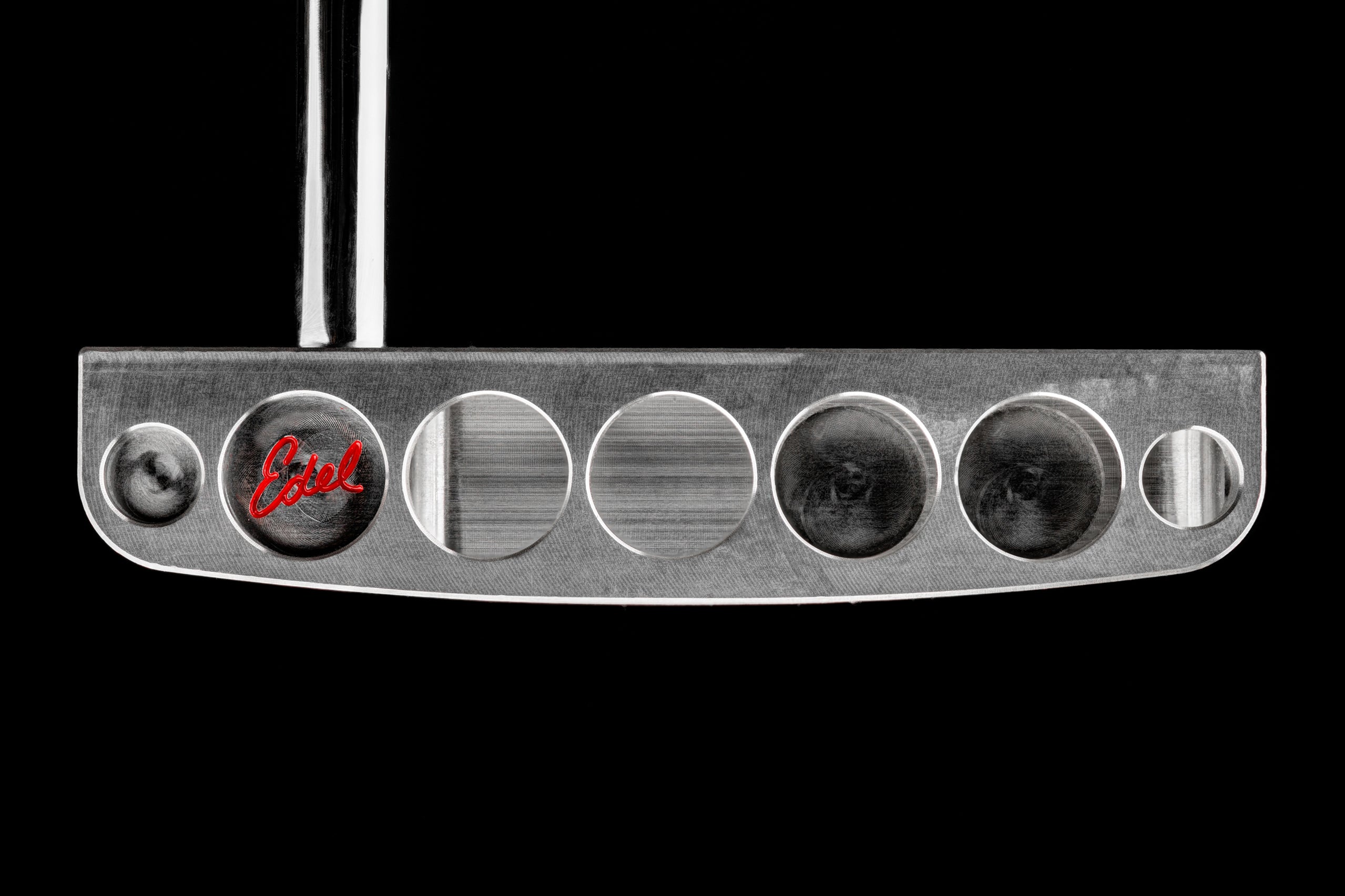 Close-up of The Brick blade putter by Edel Golf, showcasing its sleek design and precision milling details.