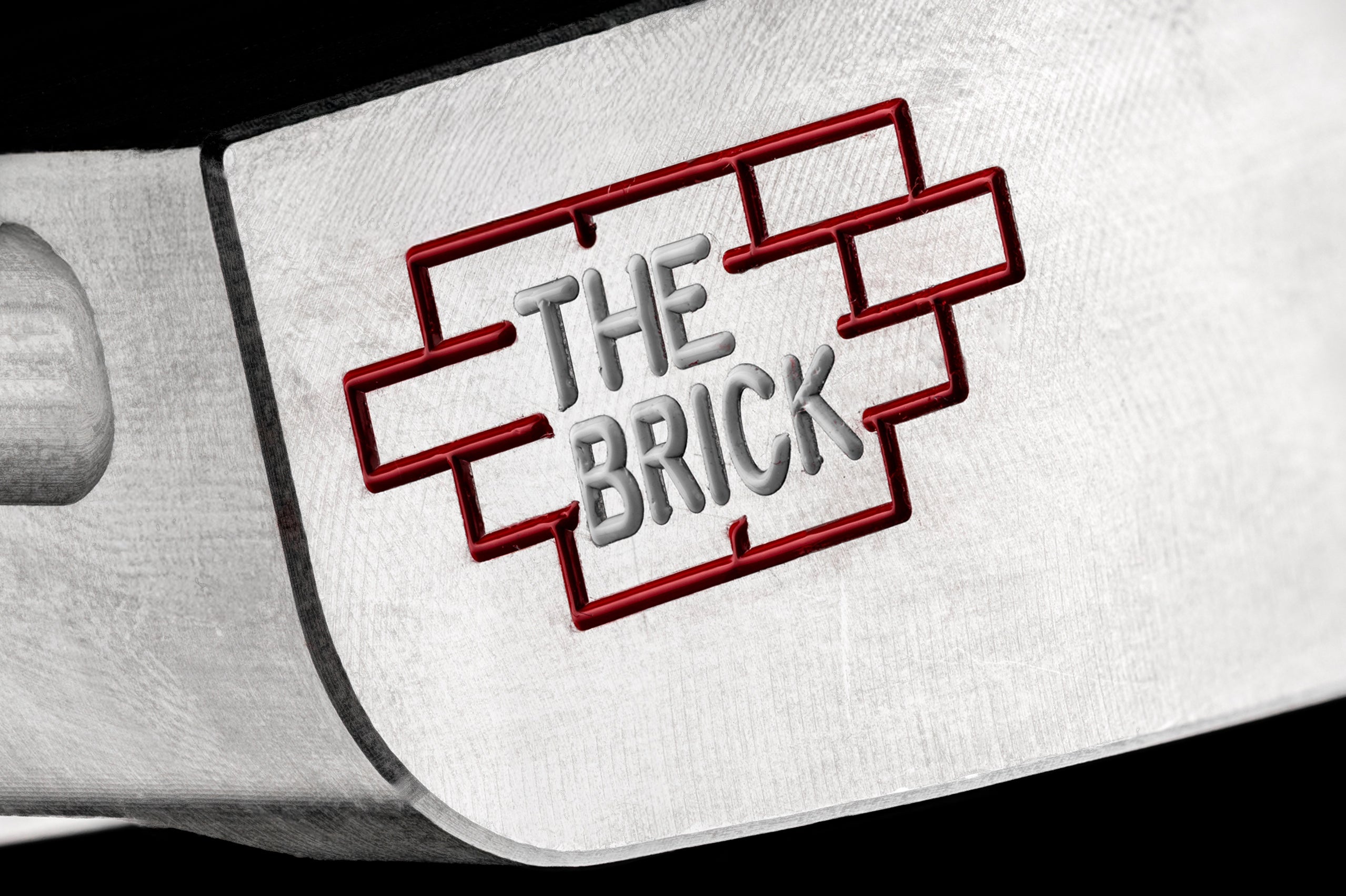 Close-up of The Brick blade putter by Edel Golf, showcasing its engraved logo and sleek design for precision putting.