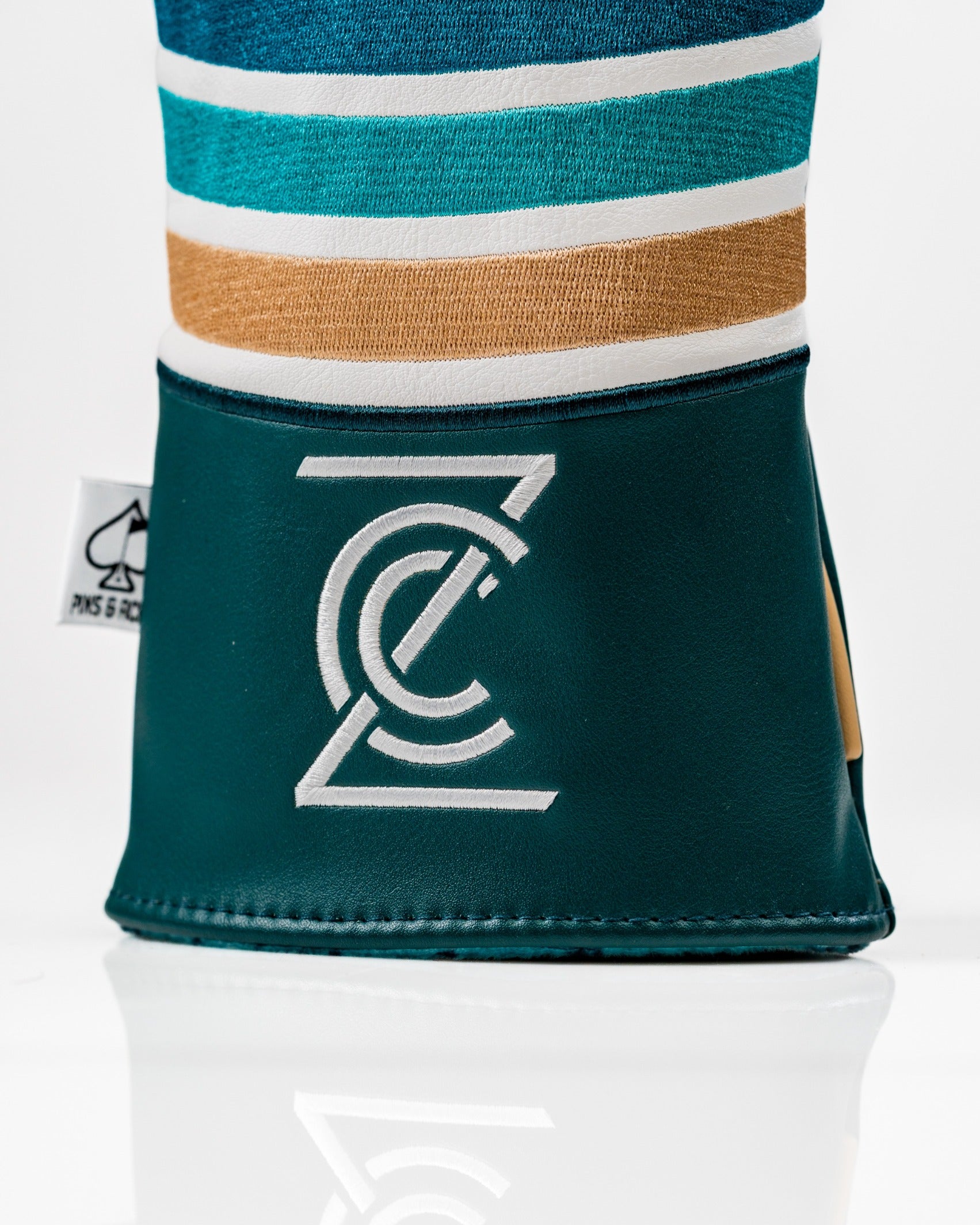 Bold driver cover featuring vibrant stripes and a sleek logo, designed for golfers seeking unique style on the course.