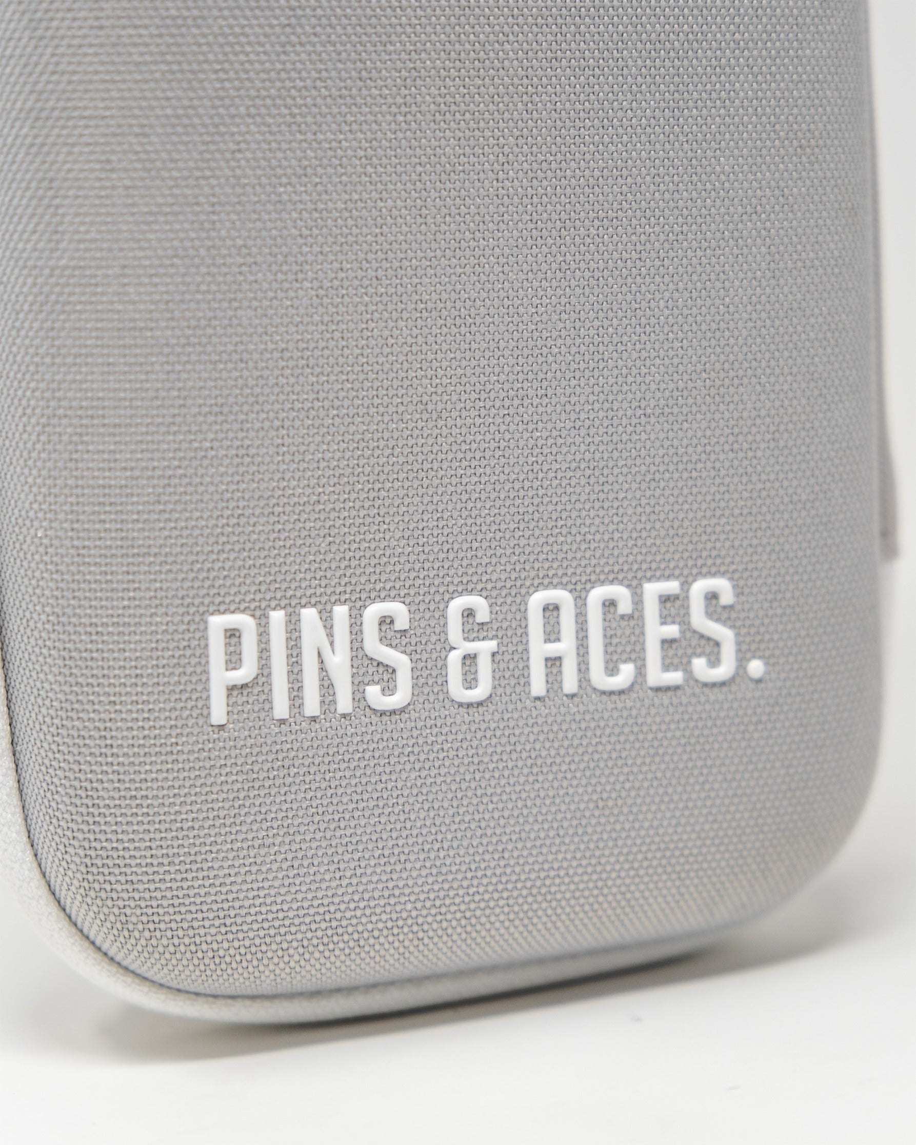 Gray glove and accessory caddie featuring the Pins & Aces logo, designed for golfers to organize their gear stylishly.