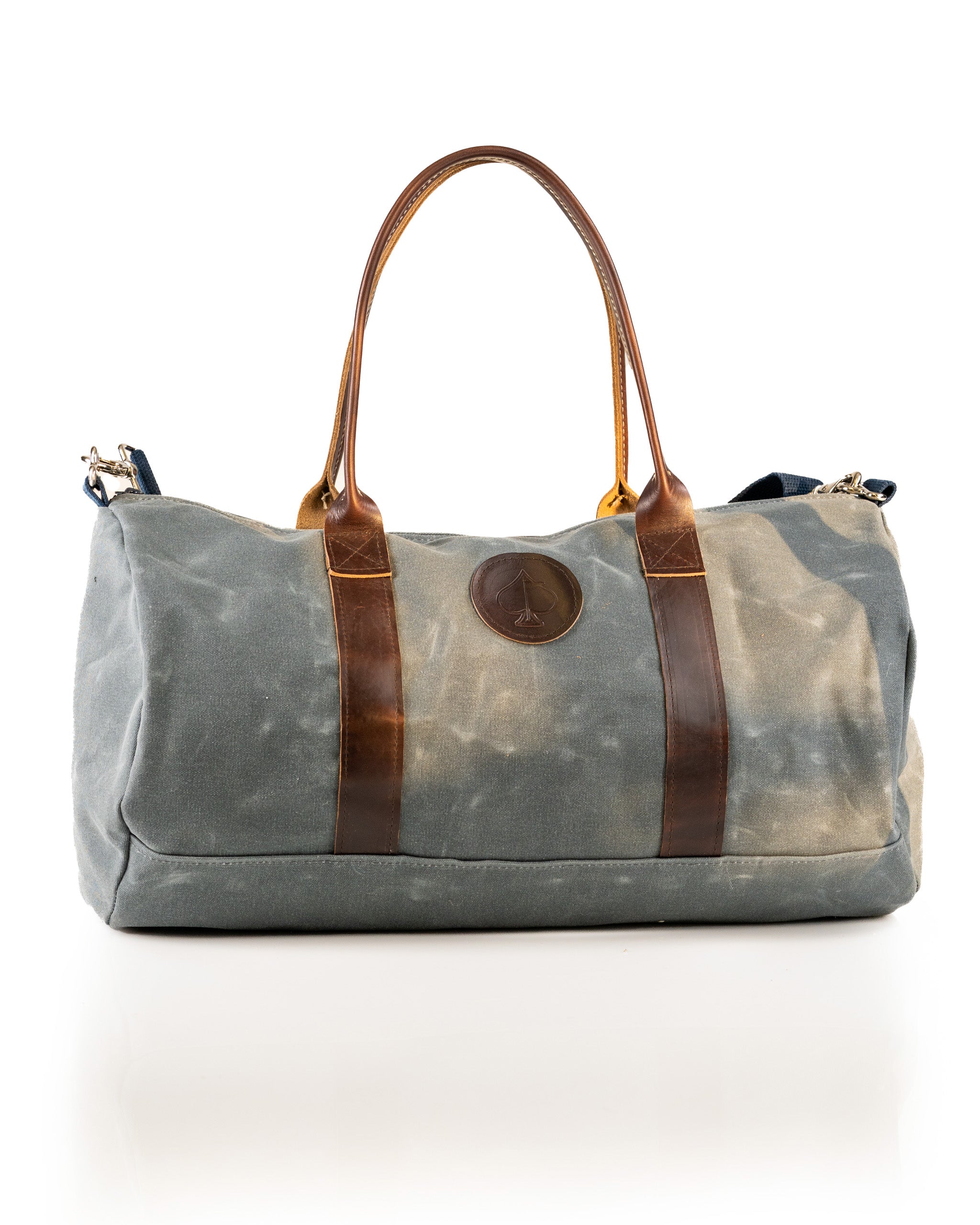 Stylish duffel bag featuring a durable canvas exterior and leather accents, perfect for travel and gym use.