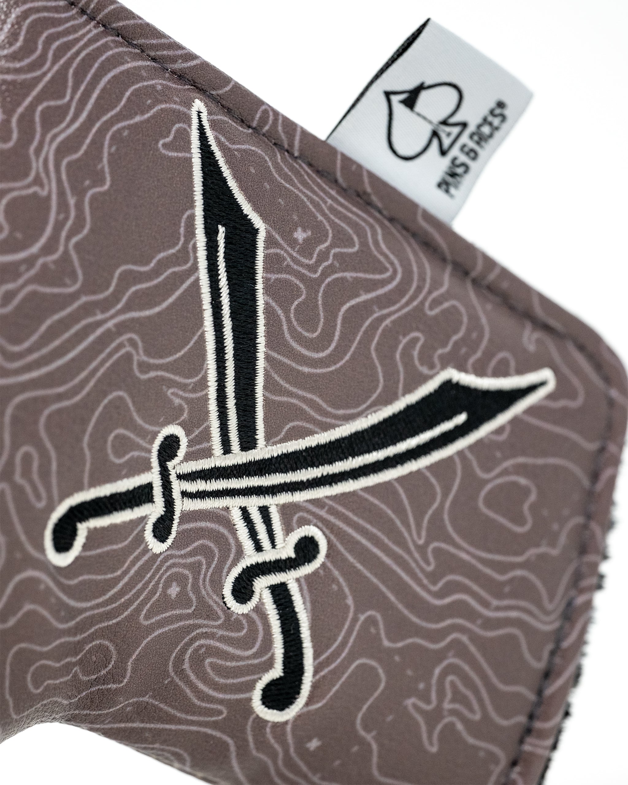 Alt text: Black and white pirate-themed blade putter cover with skull and crossbones design.