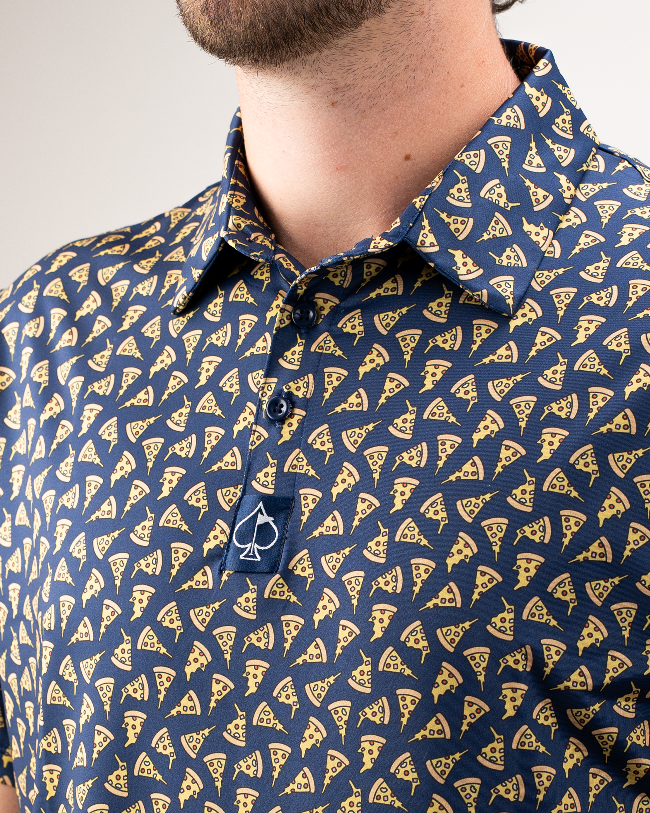 Navy golf shirt featuring a playful pizza slice pattern, perfect for adding fun to your golf attire.