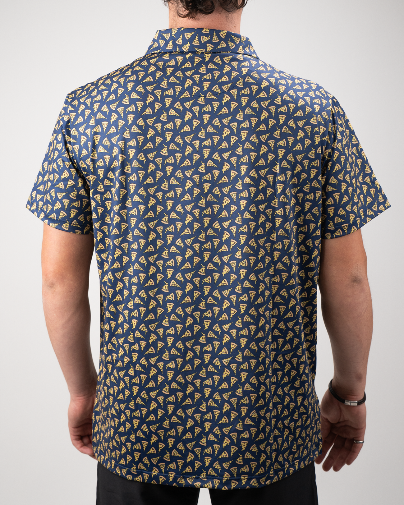 Men's short-sleeve shirt featuring a playful pizza slice pattern on a navy background, ideal for casual outings.