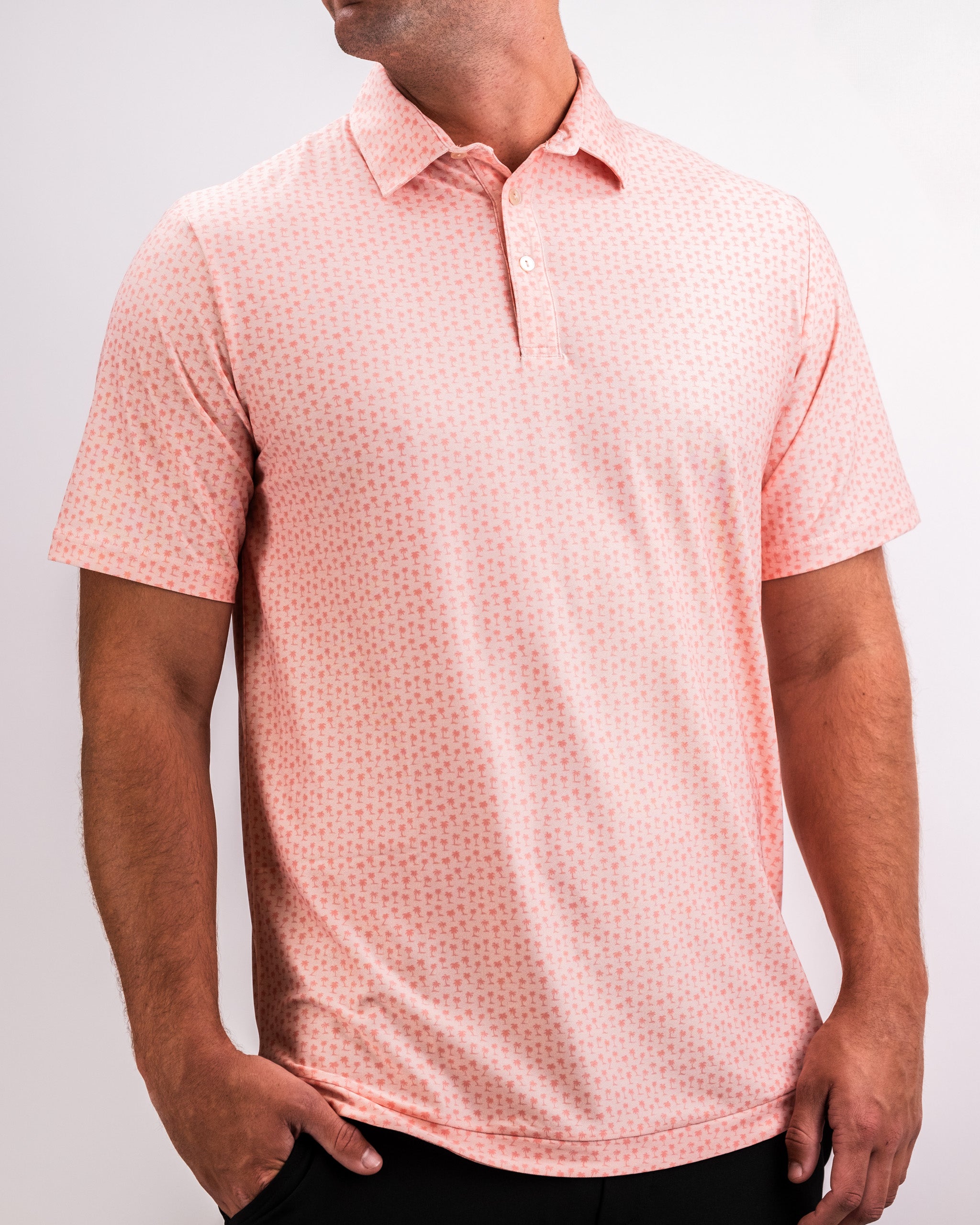 Pink golf polo shirt with small red cross pattern, classic collar, and button placket, perfect for bold golf style.