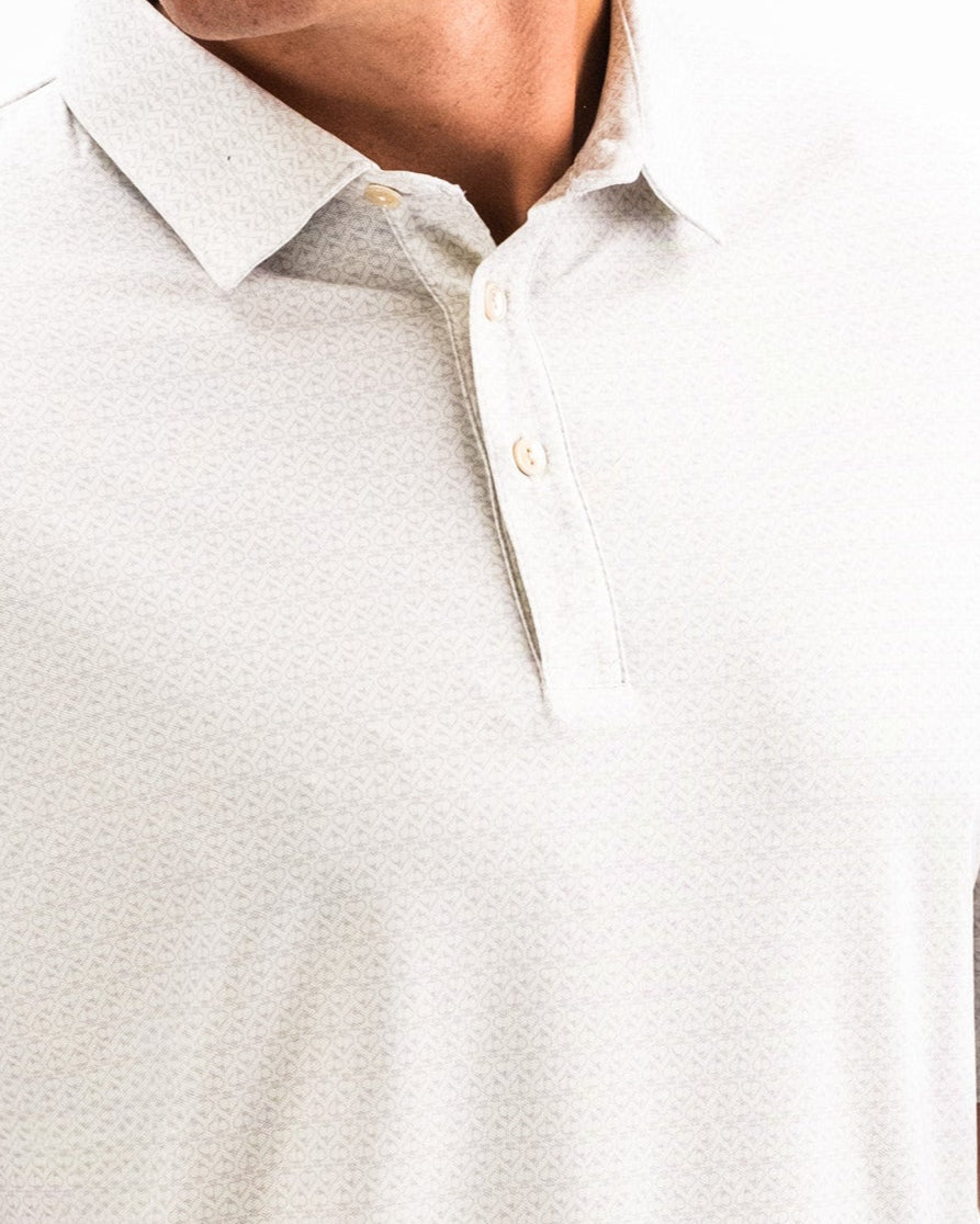 Close-up of a white golf polo with subtle textured pattern and light-colored buttons, ideal for bold golf style.