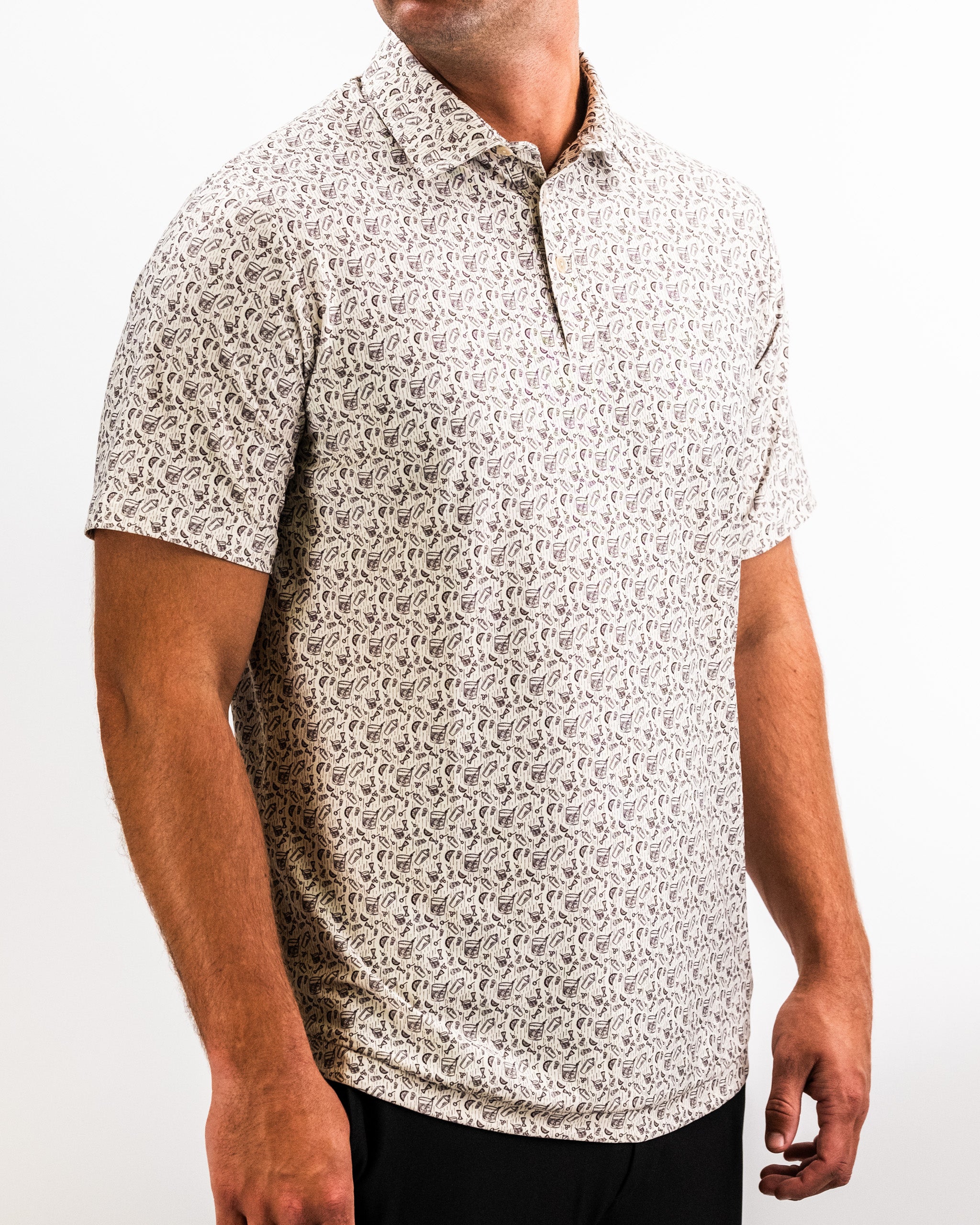 Men's beige golf shirt with a small abstract black and purple pattern, classic collar, short sleeves, and button placket.