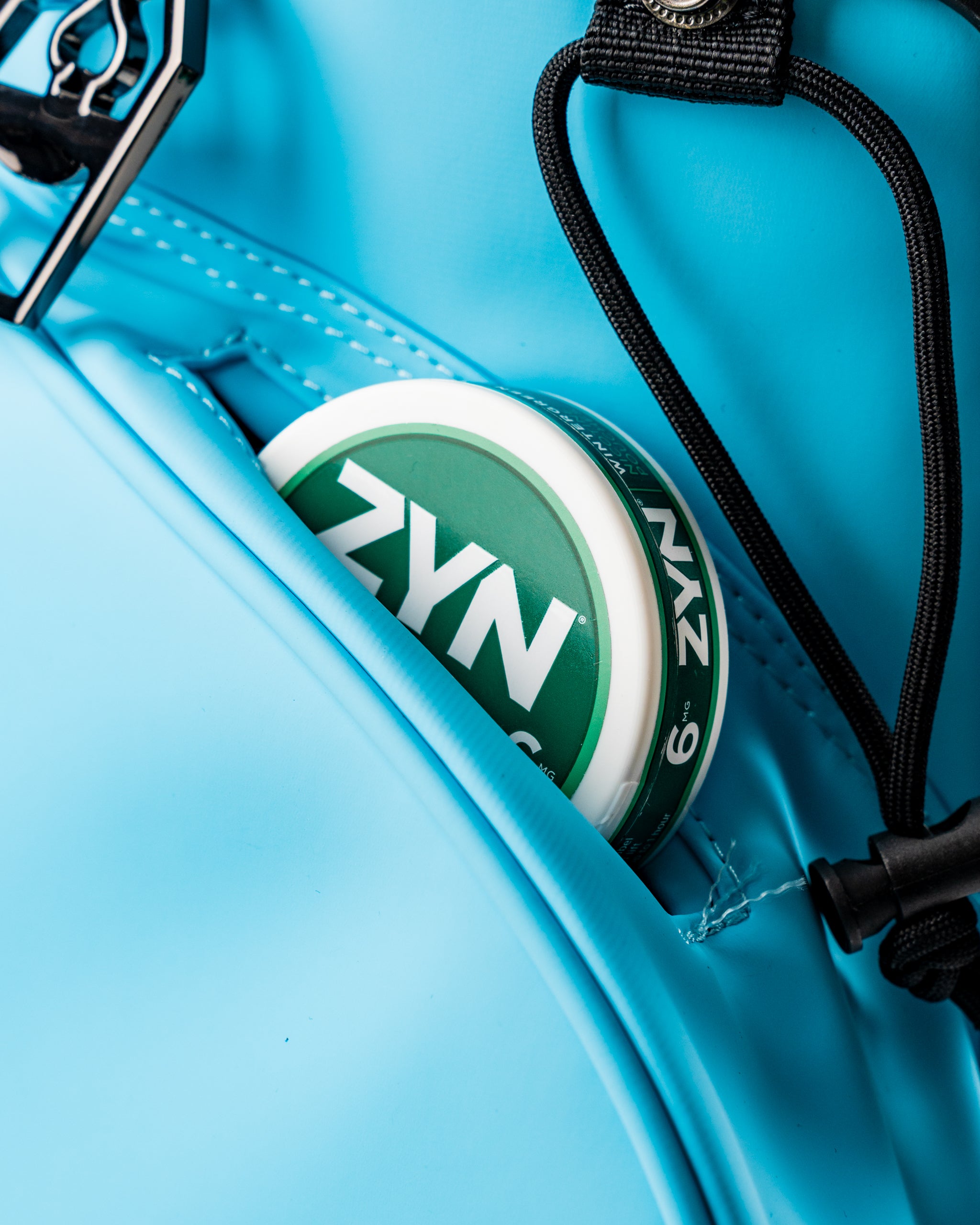 Close-up of a Glacier Player Preferred™ Golf Bag pocket featuring a can of ZYN, showcasing its vibrant blue color and storage design.
