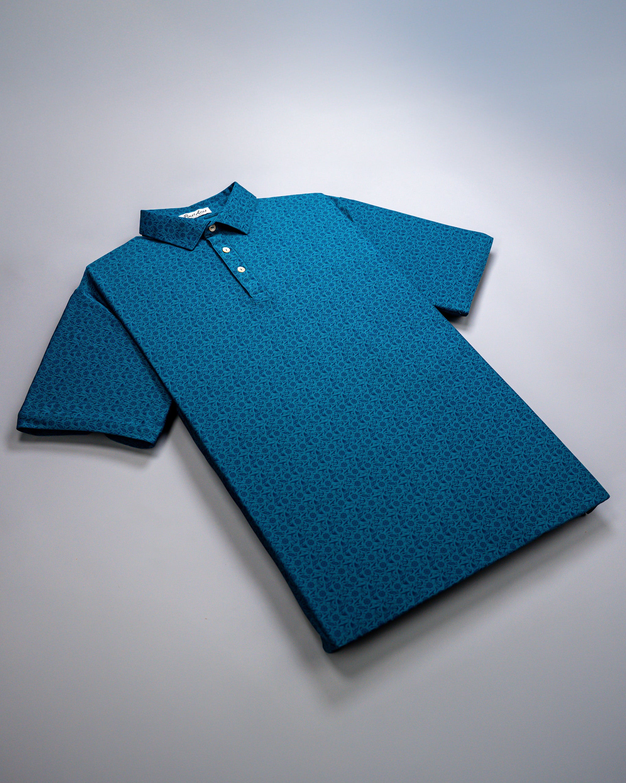 Blue Player Preferred™ Polo shirt with a small floral pattern, short sleeves, and a collar, laid flat on a white surface.