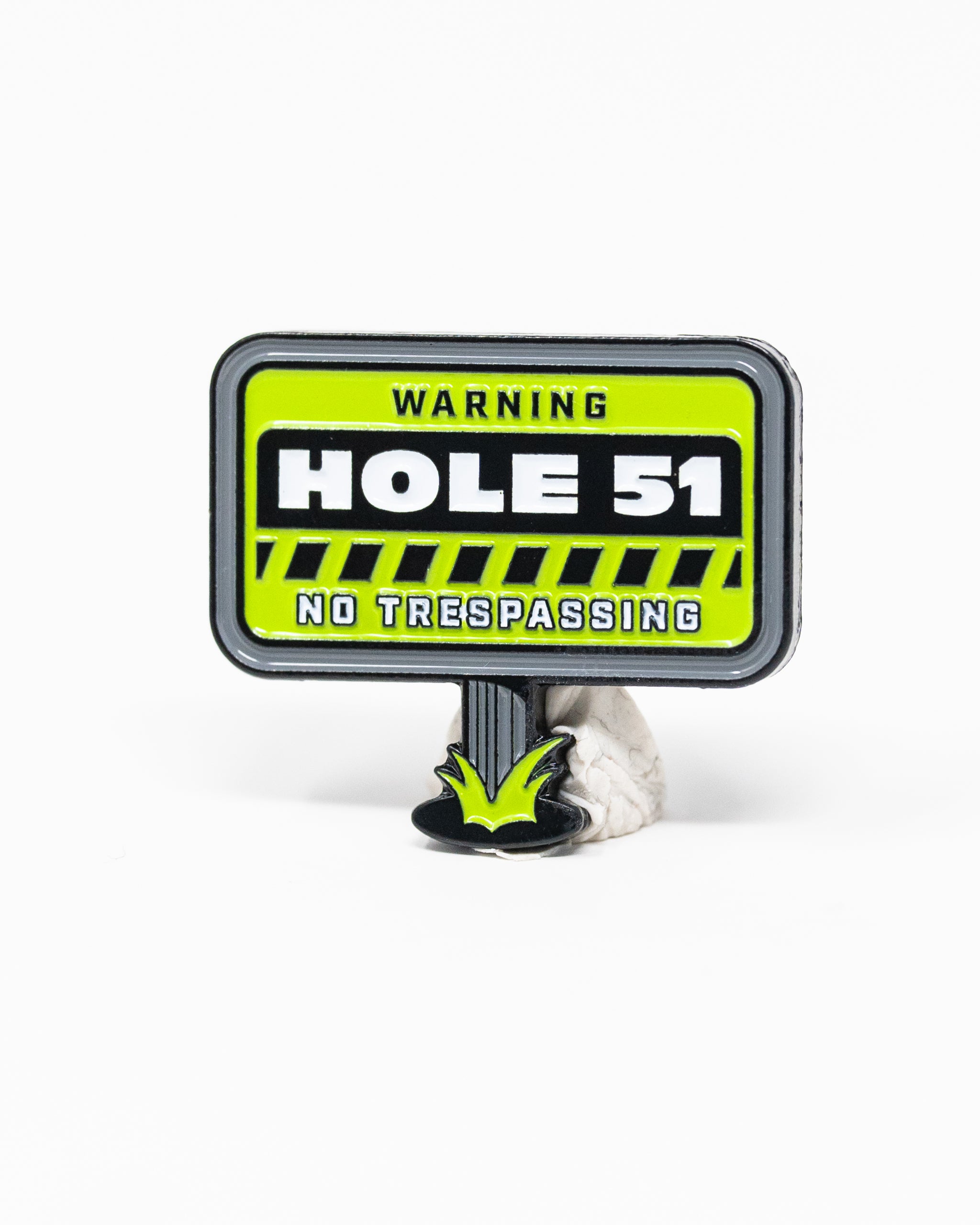 HEYDUDE Hole 51 Ball Marker with a circular design and colorful graphic, featuring the brand logo.