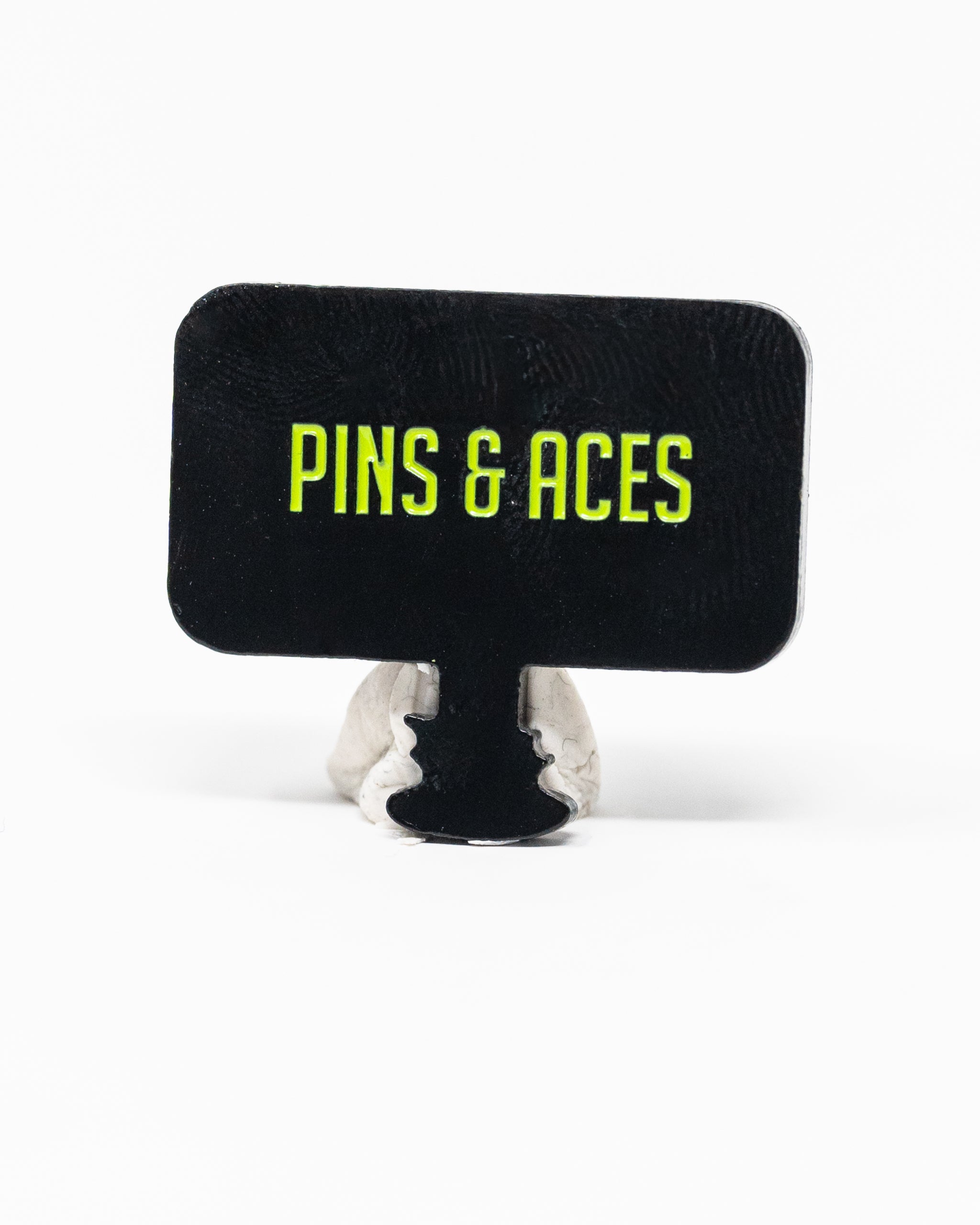 HEYDUDE Hole 51 Ball Marker featuring a circular design with vibrant colors and logo, ideal for golf enthusiasts.