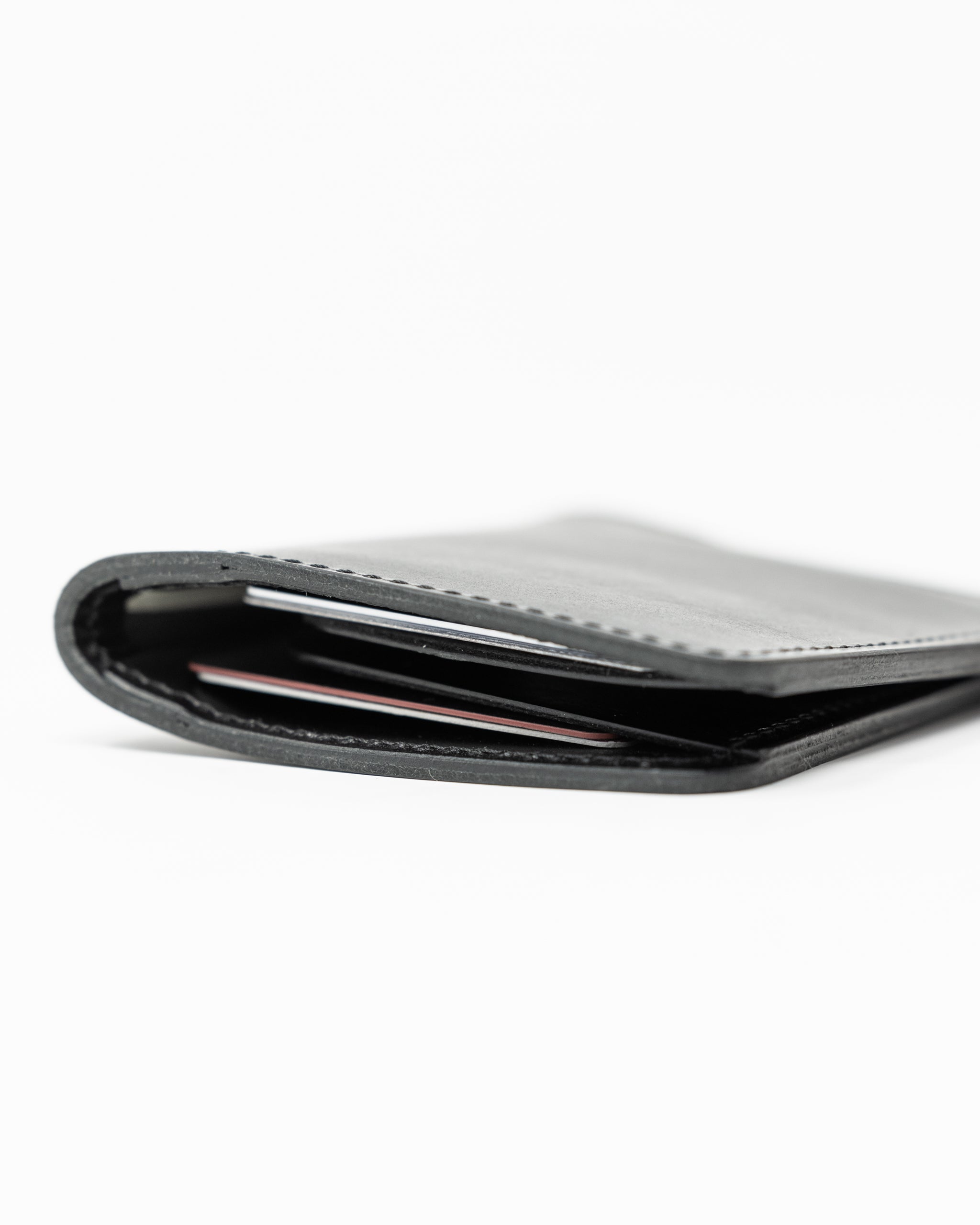 Miles Wallet in smooth Italian black leather, showcasing minimalist design and elegant texture.