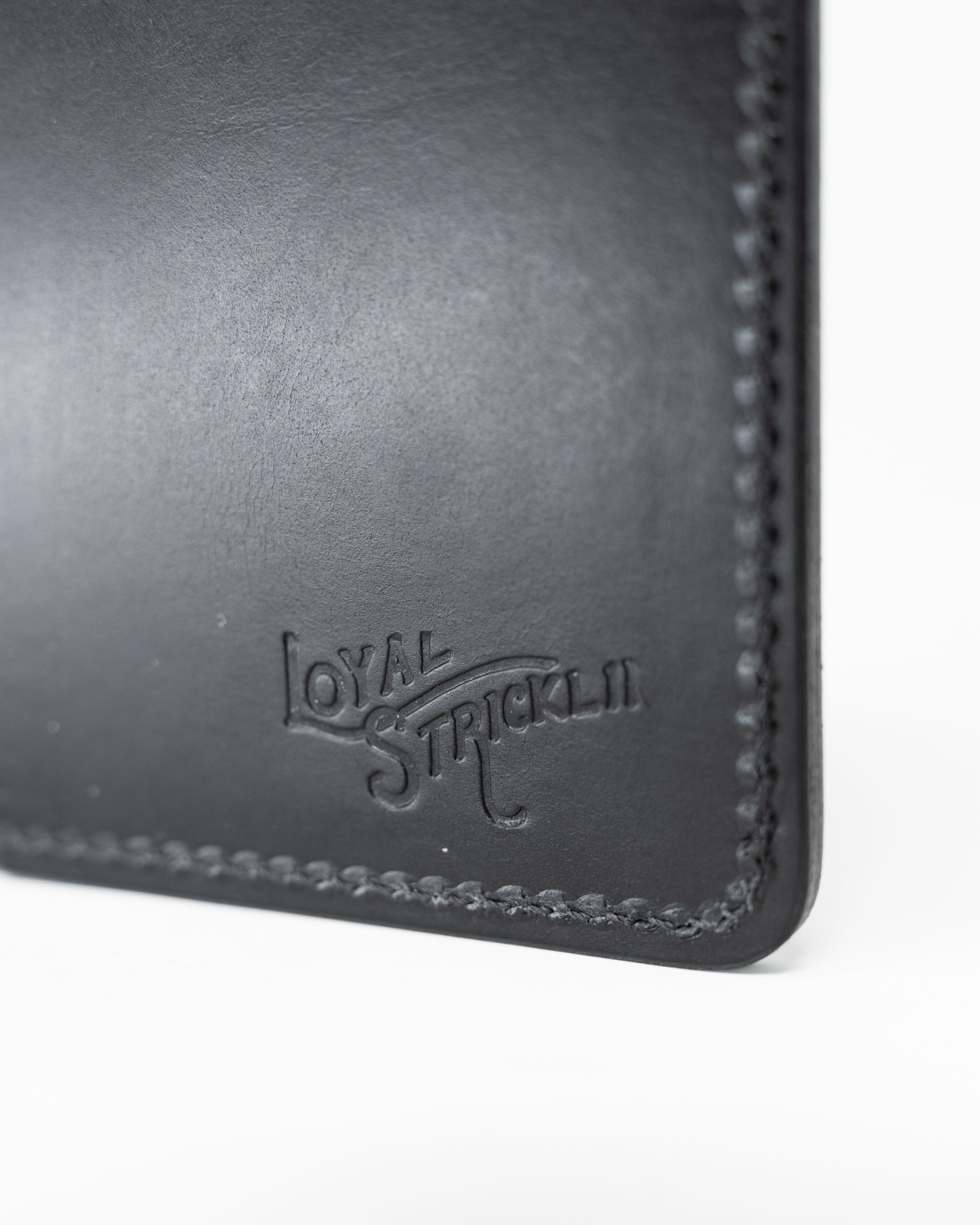Miles Wallet in smooth Italian black leather, featuring a sleek design and visible stitching details.