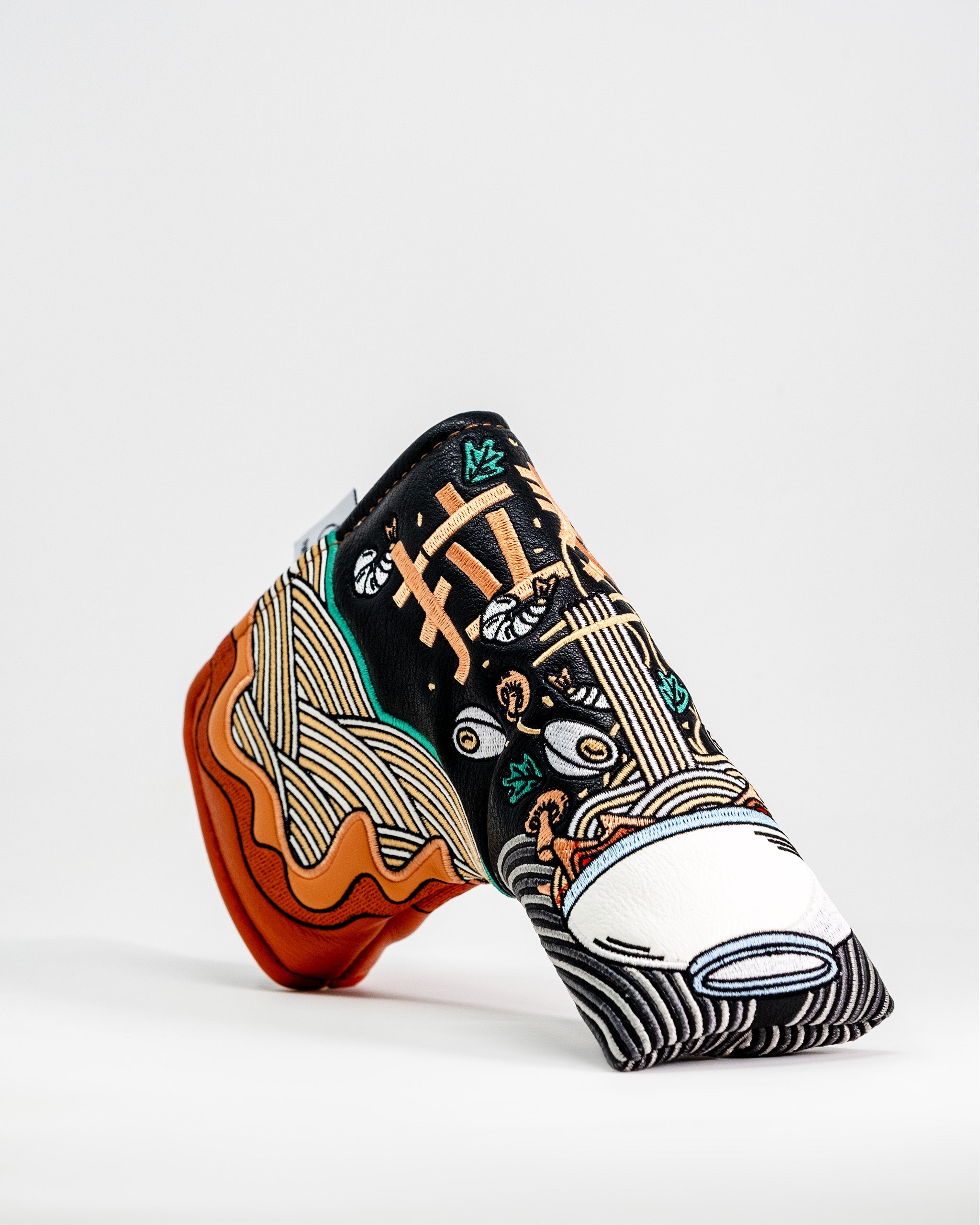 Colorful ramen bowl design Blade Putter Cover with embroidered noodles, chopsticks, and soup elements on black fabric.