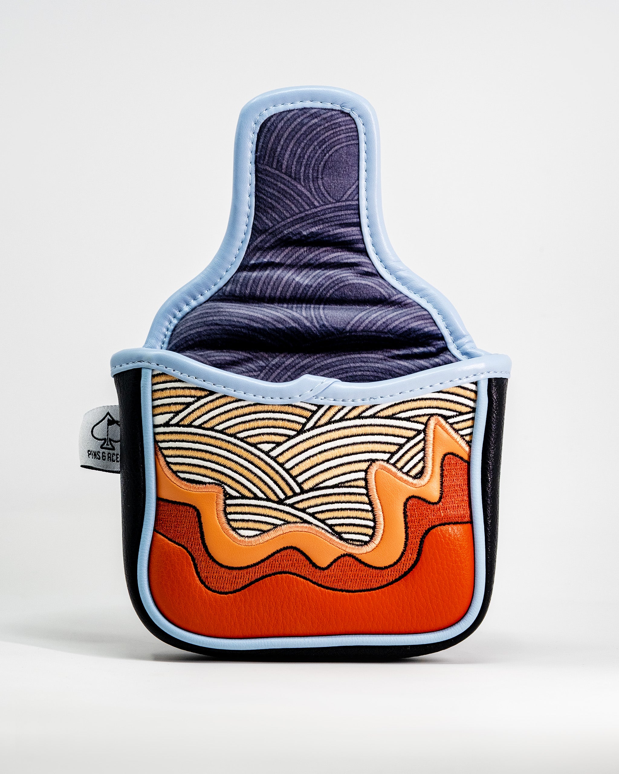 Colorful ramen bowl-shaped mallet putter cover with embroidered noodles and orange broth design, with a light blue trim.