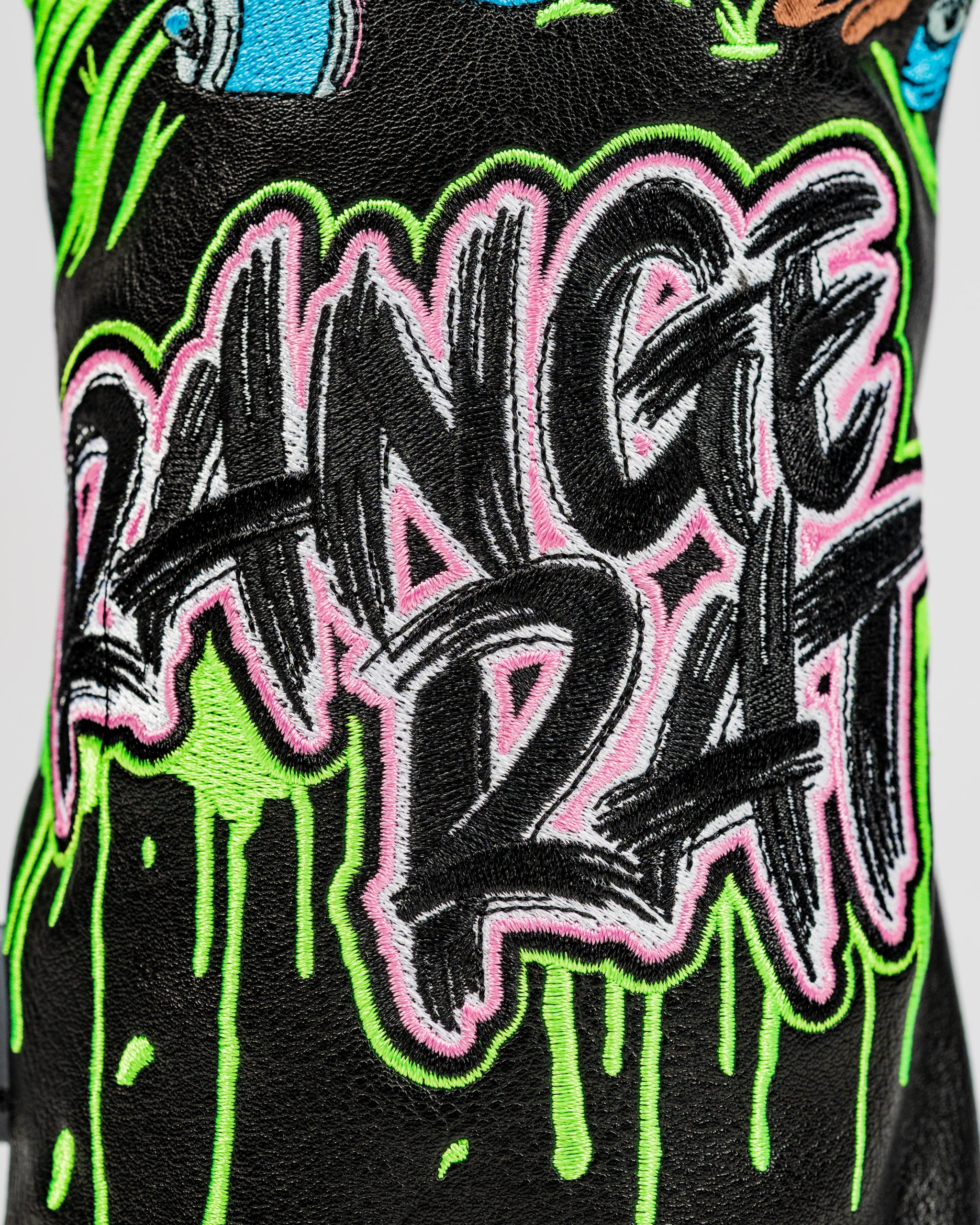 Bold driver cover featuring vibrant "Range Rat" embroidery with a graffiti-style design and colorful dripping accents.