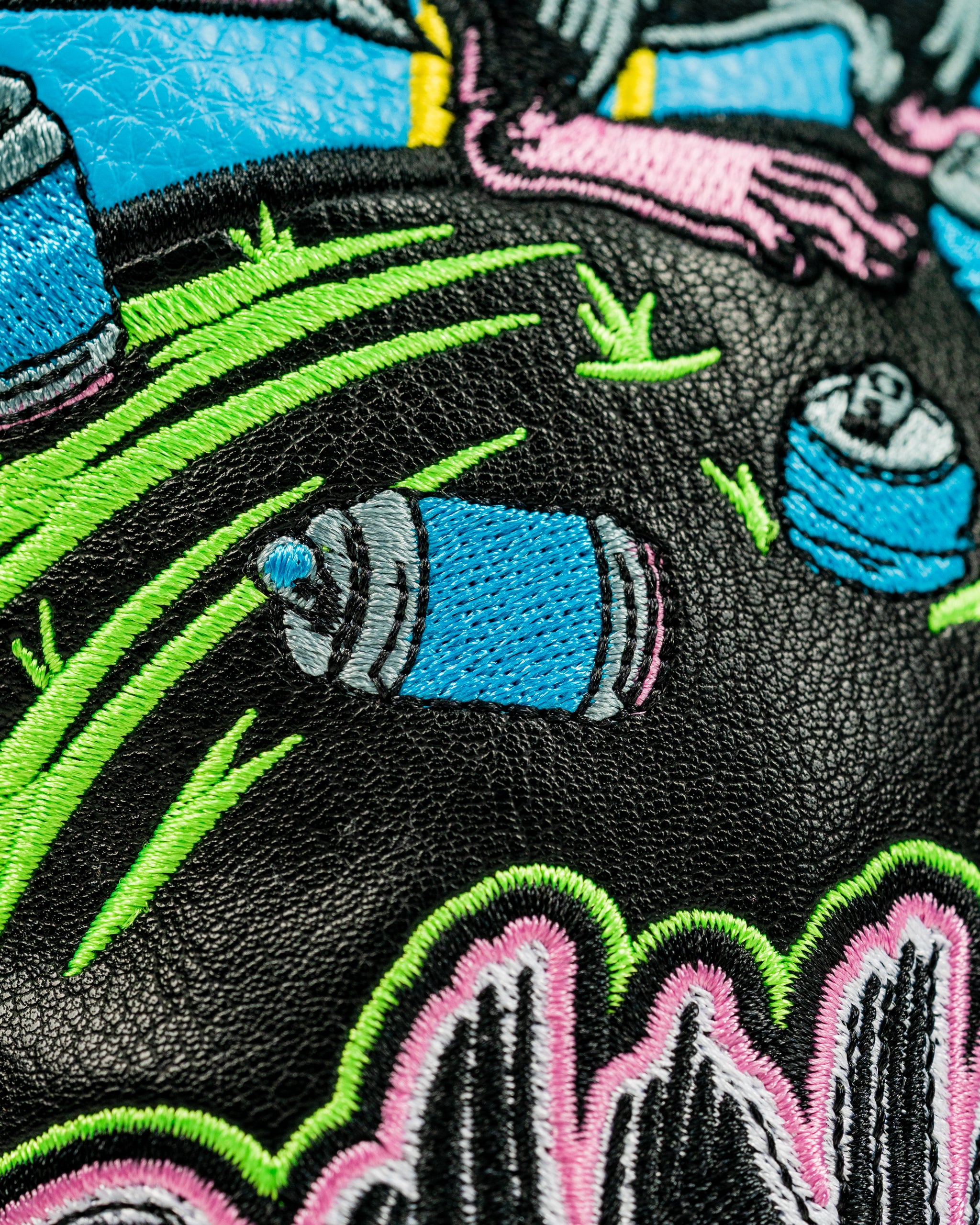 Bold driver cover featuring colorful embroidery of a golfer with spray paint cans, perfect for standout golf style.
