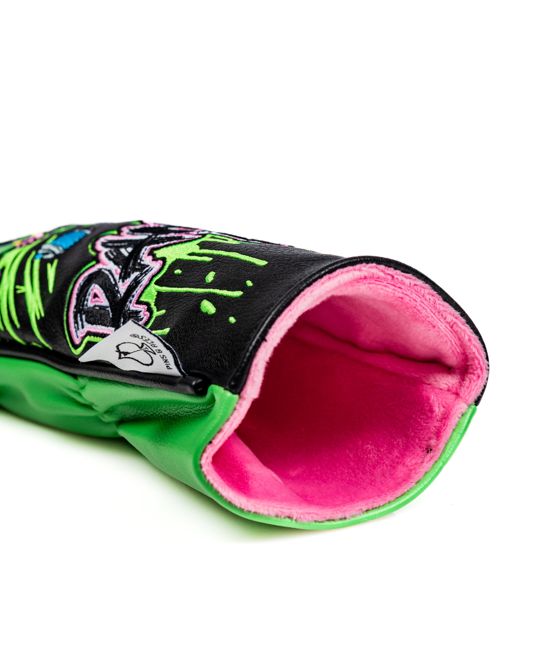 Bold fairway cover featuring vibrant graffiti-style designs and a plush pink lining, perfect for stylish golfers.
