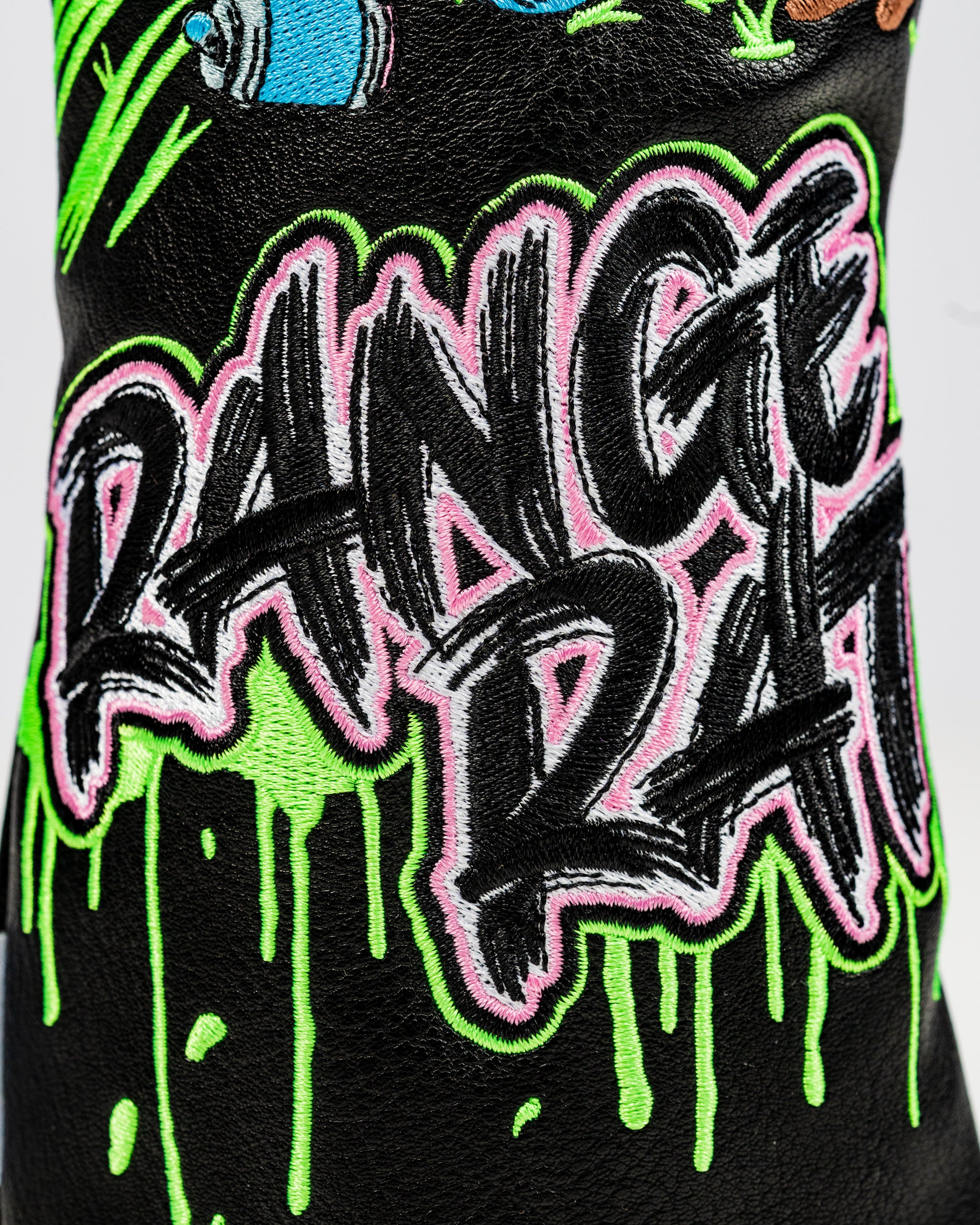 Bold black fairway cover featuring vibrant "Range Rat" embroidery in neon green and pink, perfect for standout golfers.