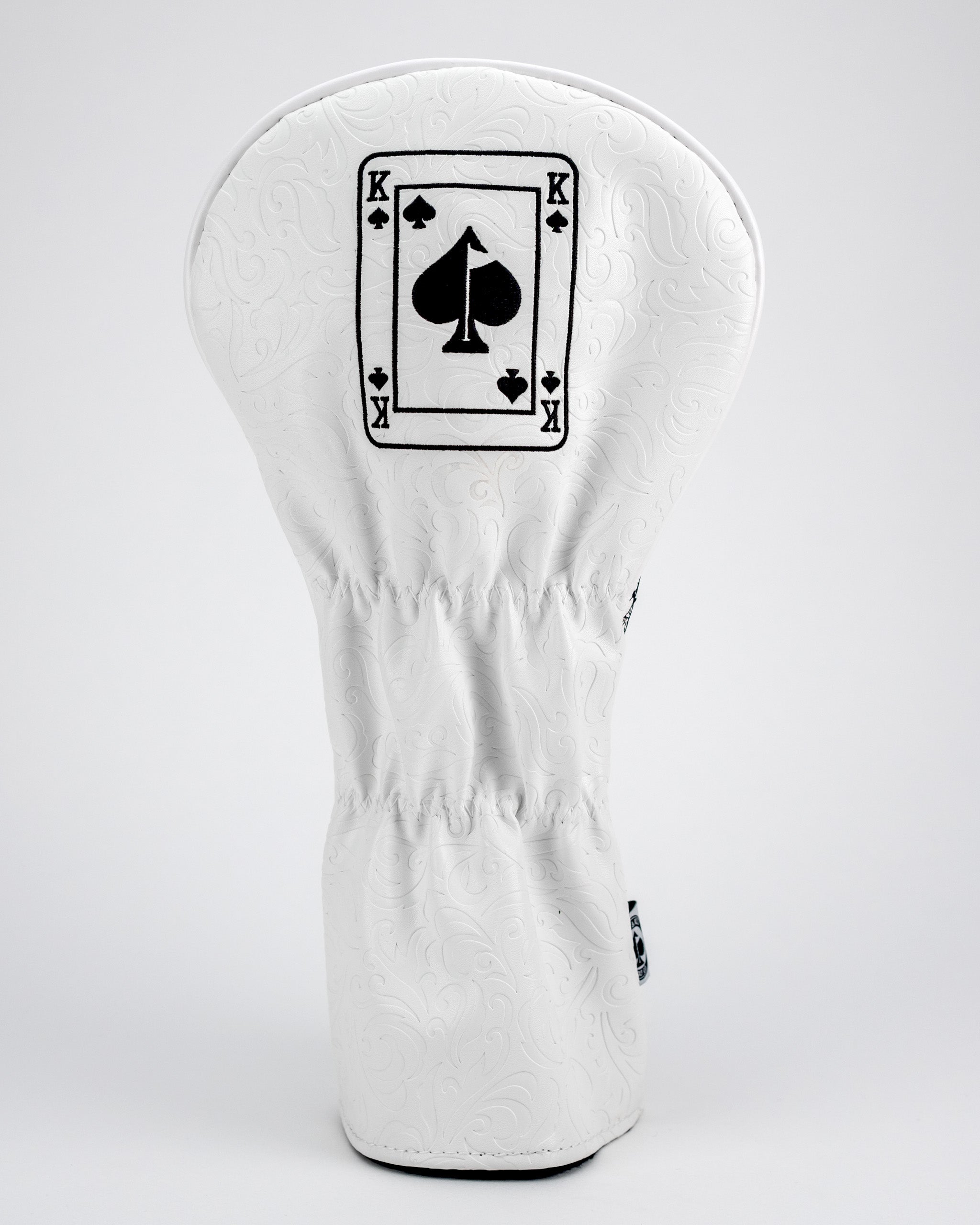 White golf headcover with a black spade and king of spades design, featuring bold, intricate embossed patterns for standou...