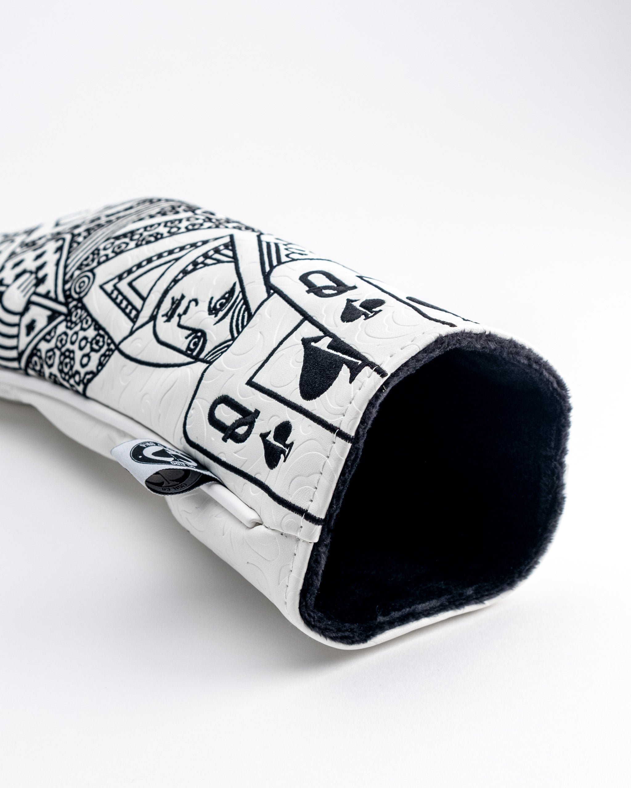 Bold black and white golf club headcover with graphic artwork, soft fleece lining, and unique design for standout style.