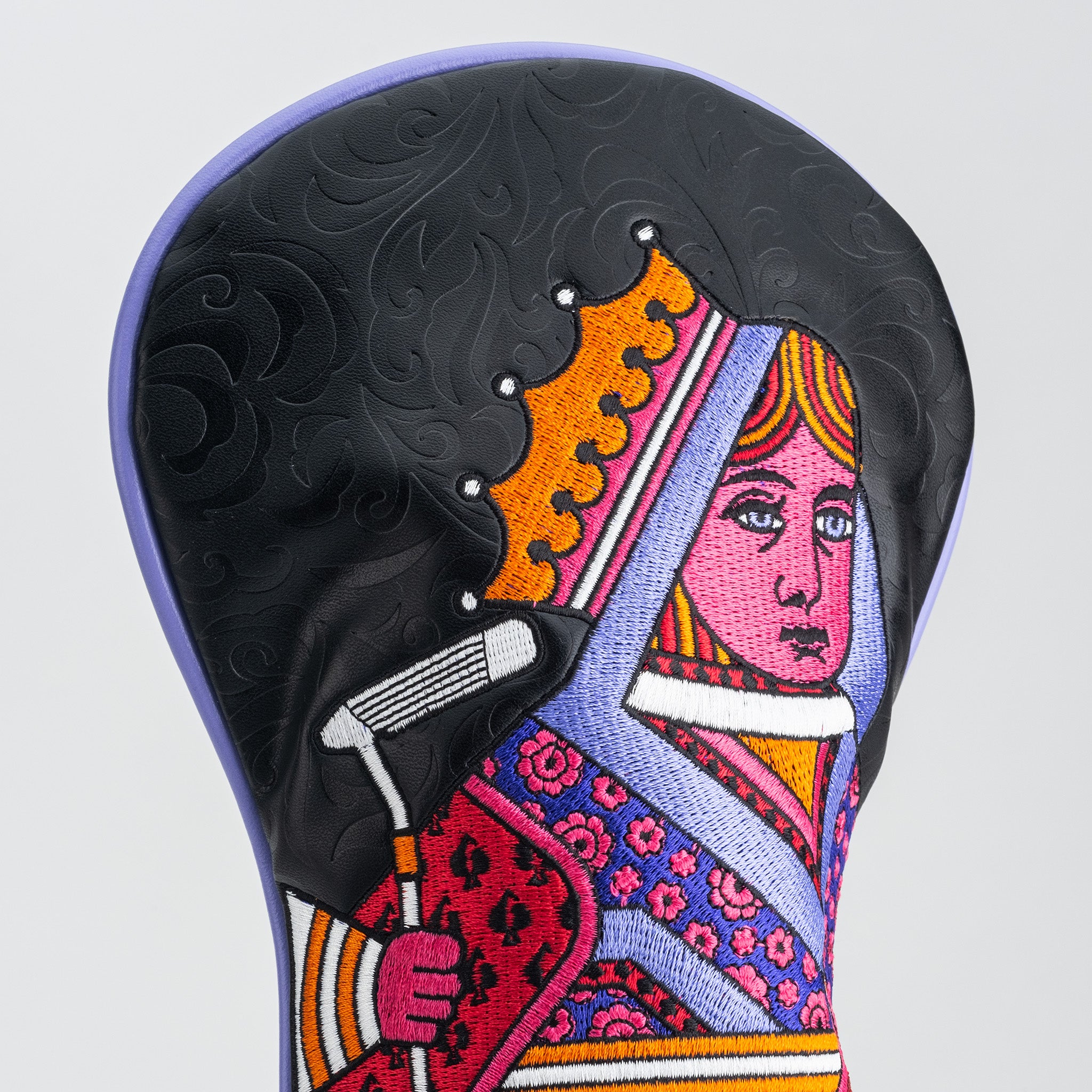 Colorful embroidered golf headcover featuring a bold, artistic queen with a golf club, vibrant pinks, purples, and orange ...