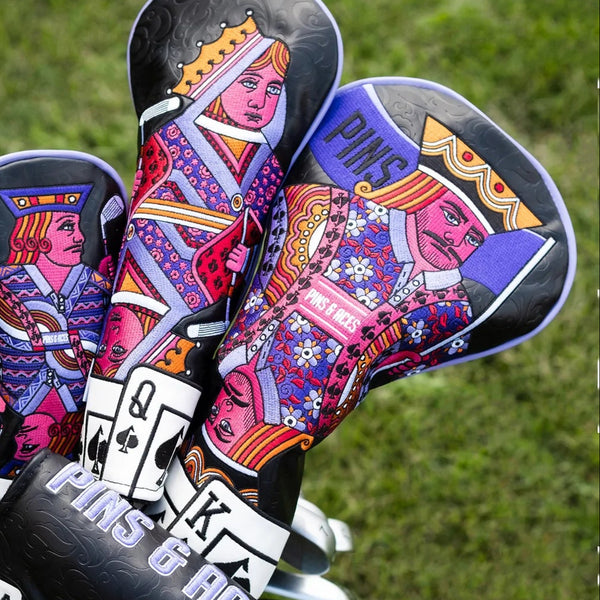 Colorful, bold golf club headcovers featuring Queen of Hearts playing card design, vibrant pink, purple, and yellow details.