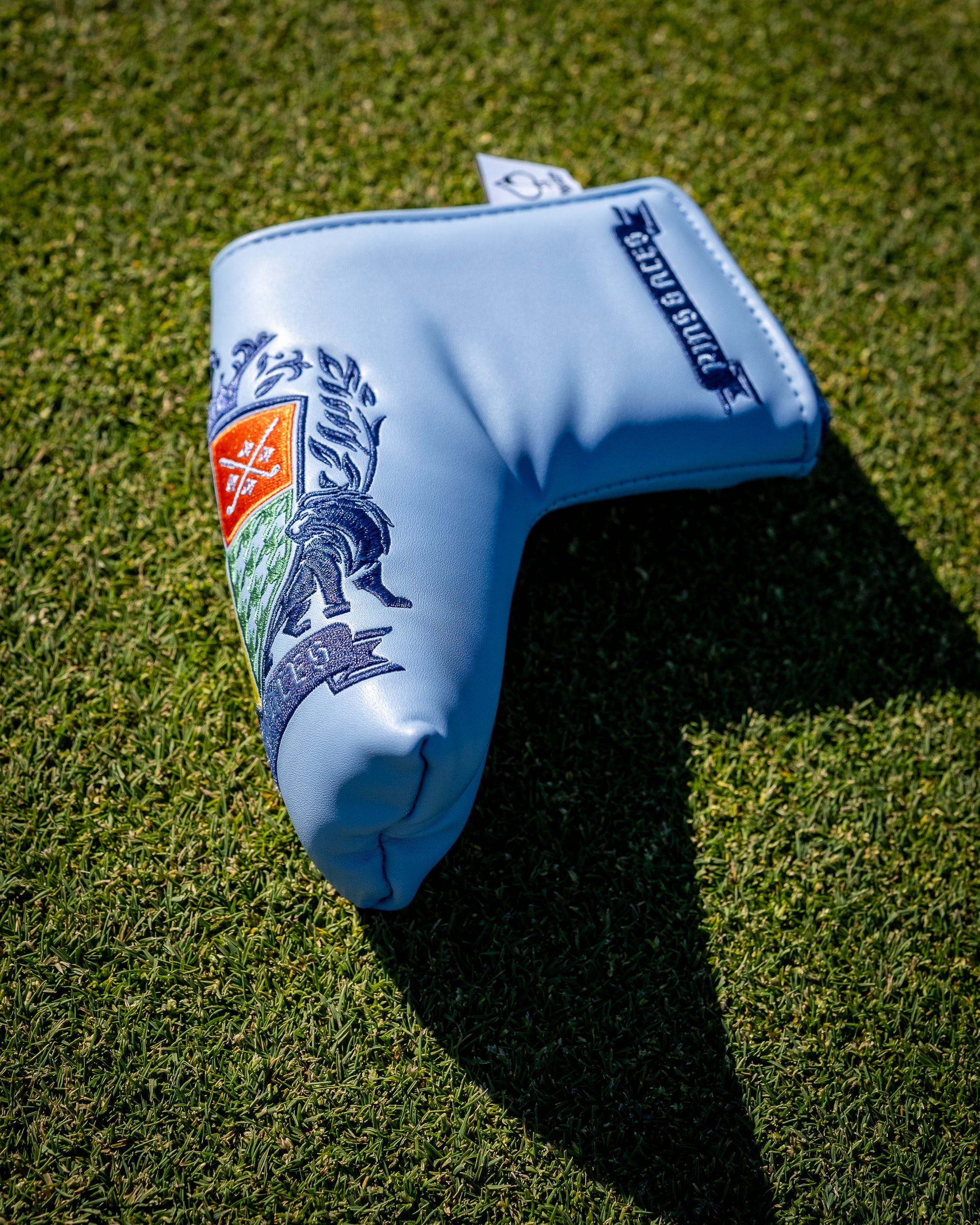 Coat of Arms Blade Putter Cover in lifestyle setting, showcasing elegant design and premium materials.