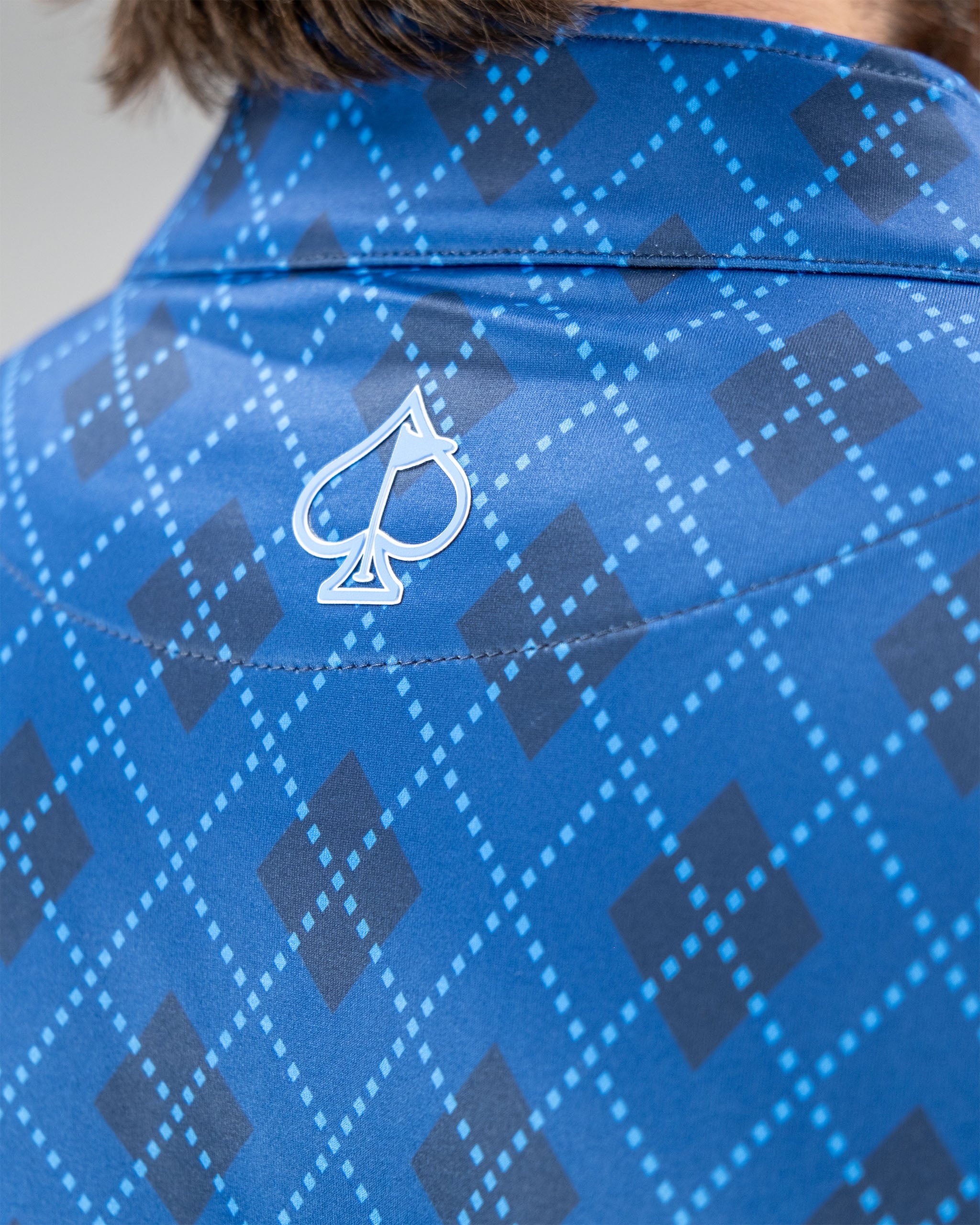 Windsor Blue Pullover featuring a diamond pattern and a logo on the back collar for a stylish look.