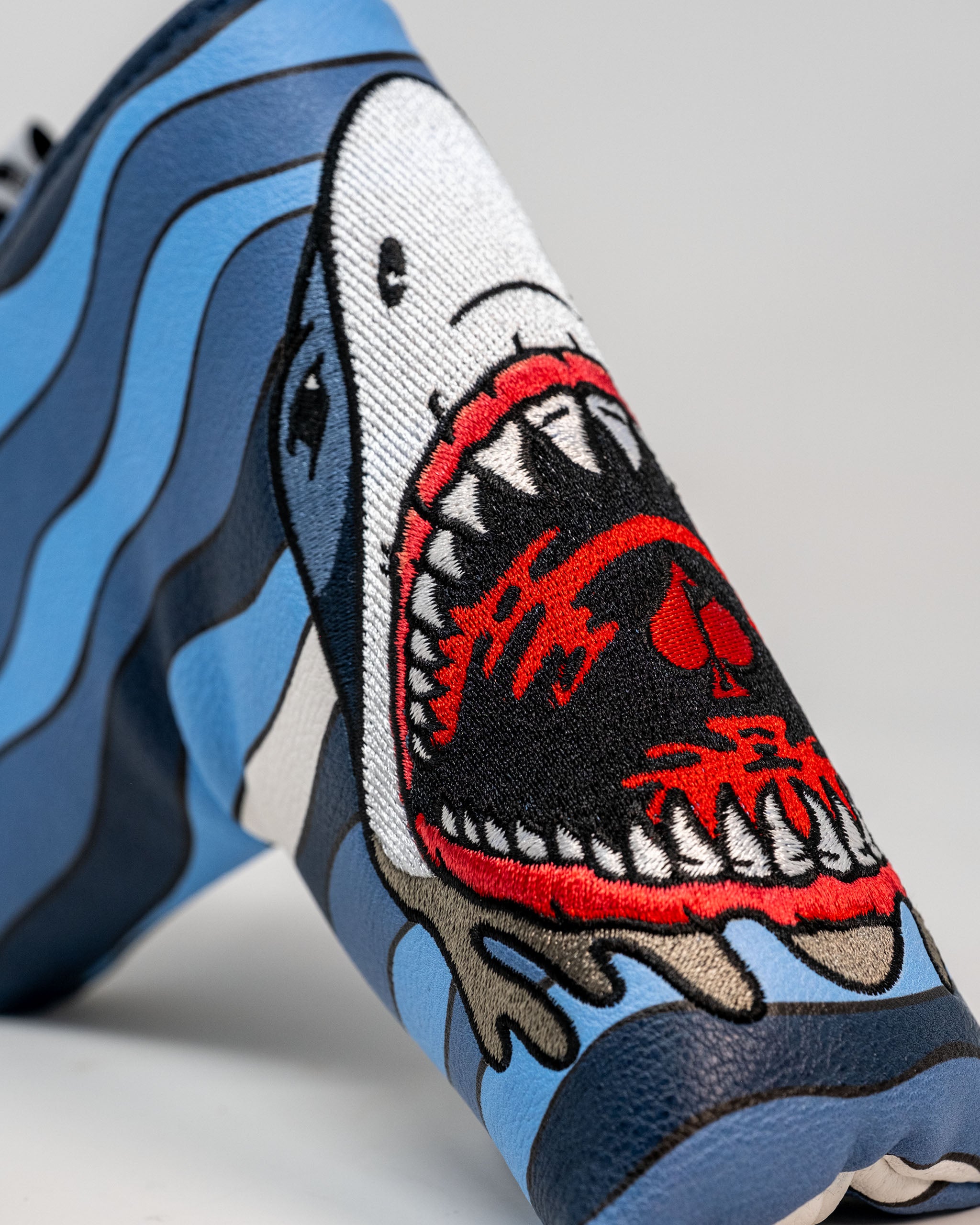 Shark Attack Blade Putter Cover featuring a vibrant shark design and durable construction, ideal for protecting golf putters.