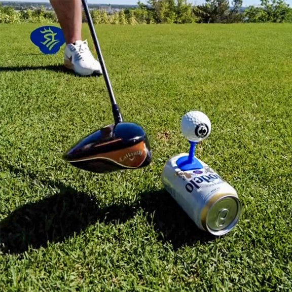 Colorful golf ball holder with a golf ball on top, placed on a soda can, on a lush green course for bold, standout golf ac...