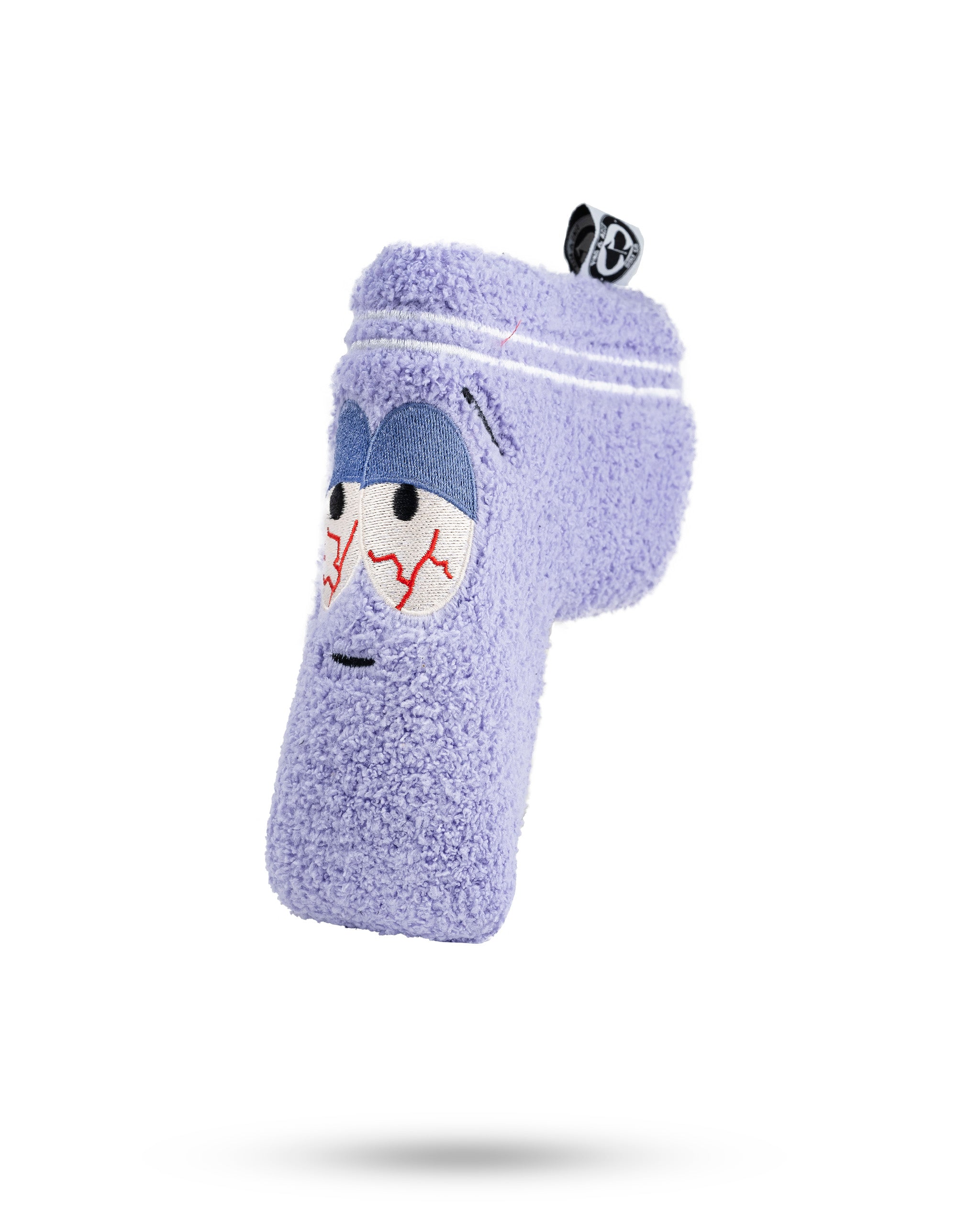 Purple fuzzy golf club headcover with cartoon face, embroidered eyes, and red stitched details, designed to stand out.