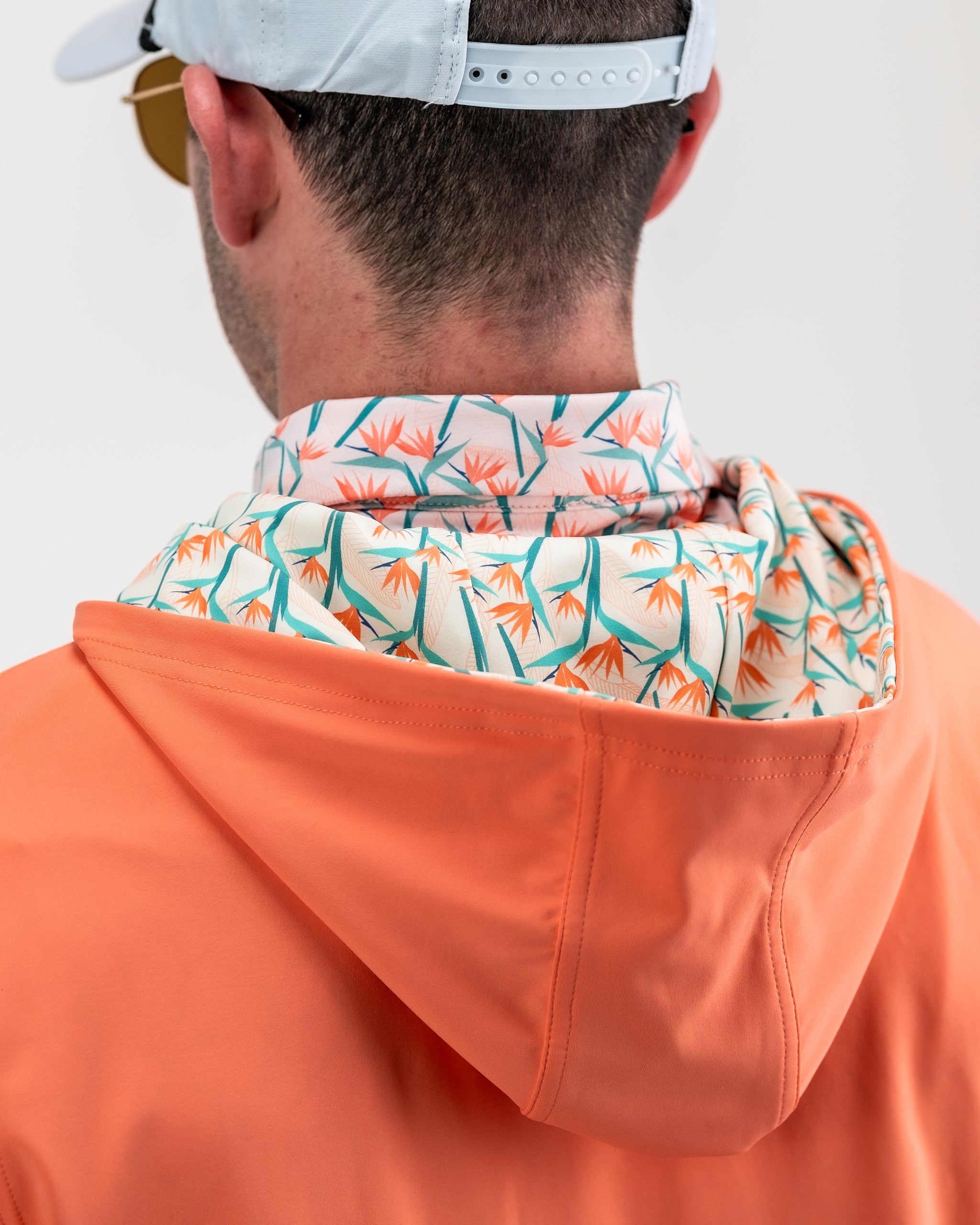 Performance Golf Hoodie featuring a vibrant Birds of Paradise design, showcasing a colorful floral pattern on a lightweight, breathable fabric.