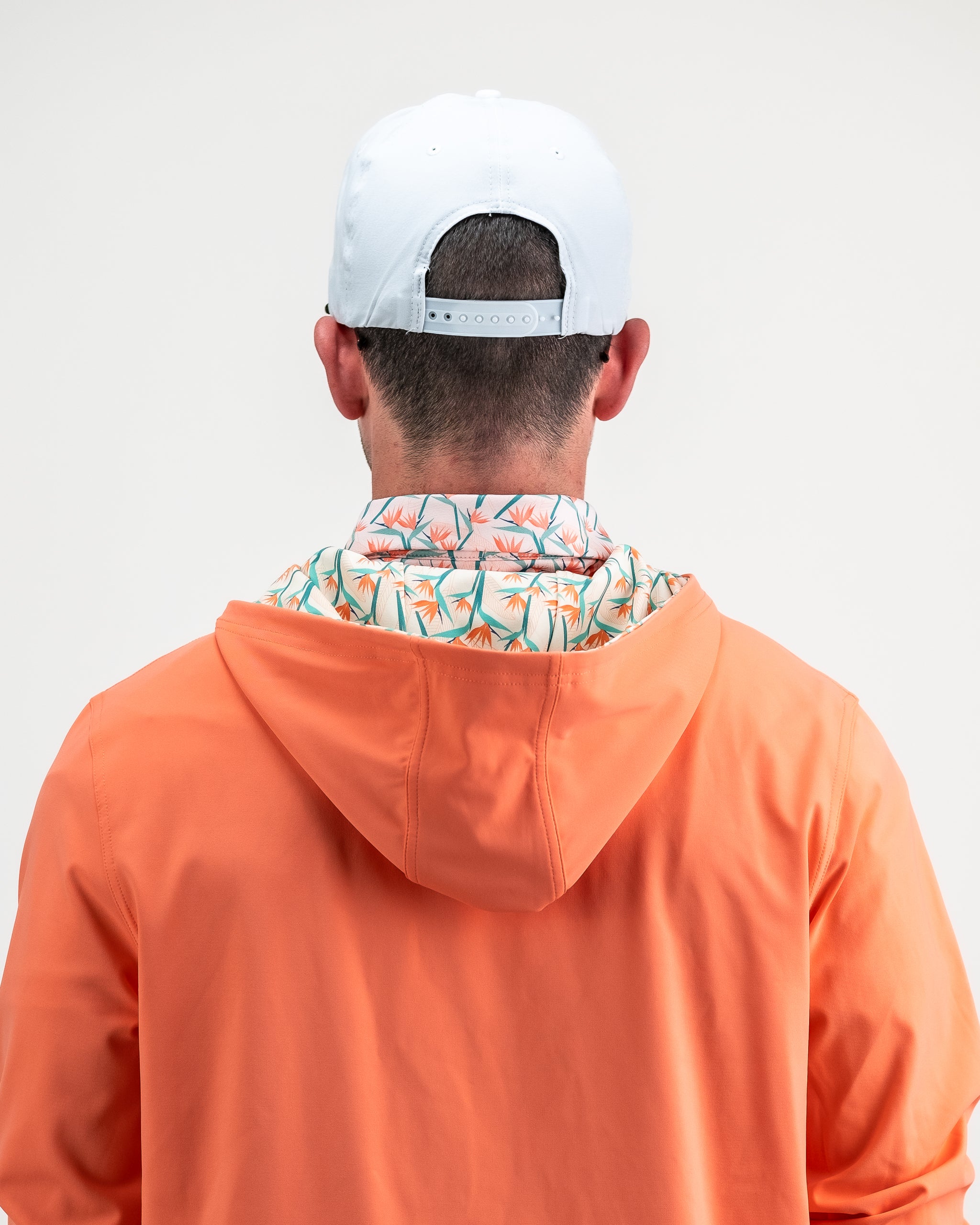 Performance Golf Hoodie in Birds of Paradise print, featuring a vibrant tropical design with shades of green, blue, and orange, ideal for activewear.