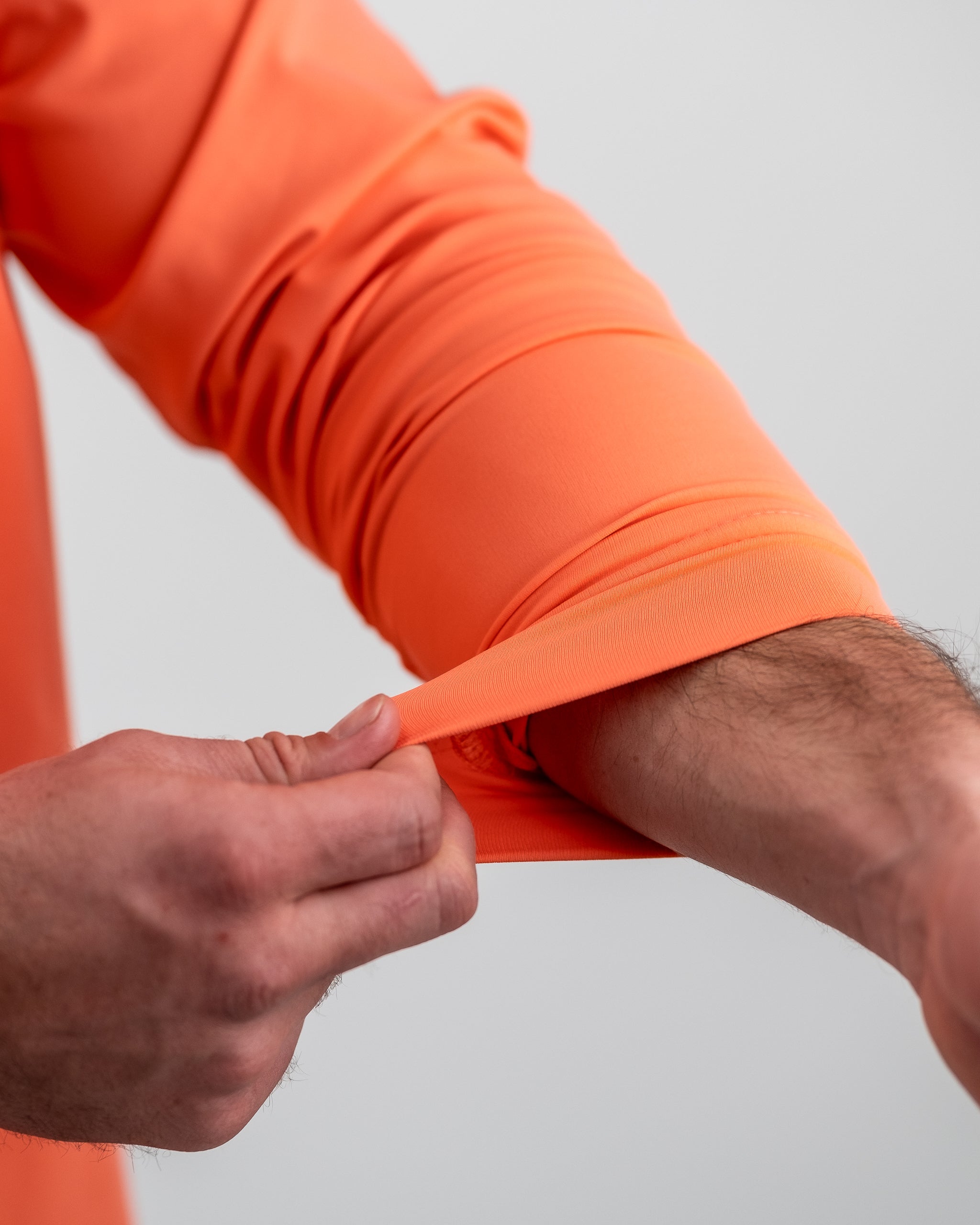 Performance Golf Hoodie featuring a vibrant Birds of Paradise design in shades of green, pink, and blue. Ideal for golf enthusiasts.