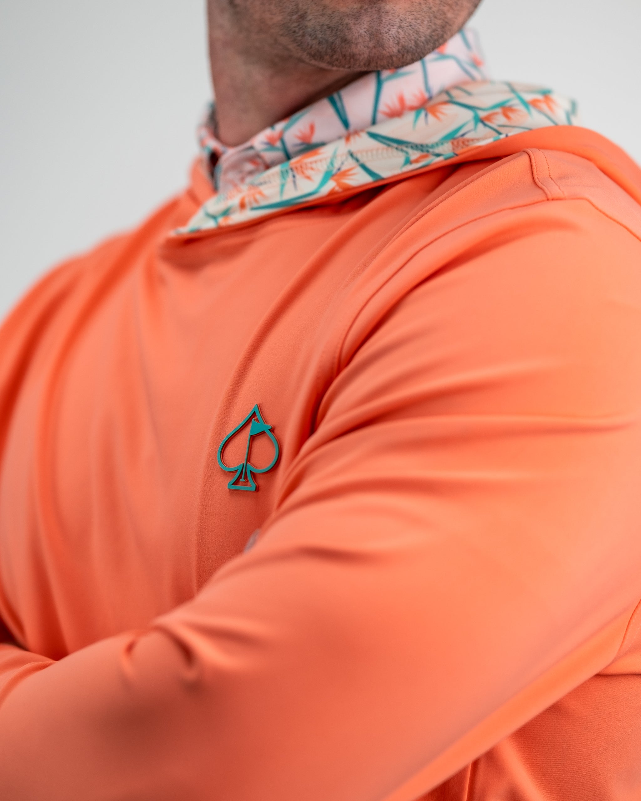 Performance Golf Hoodie in Birds of Paradise design, featuring vibrant tropical colors and a sporty hood.