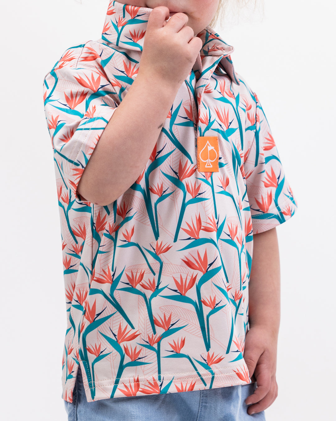 Youth Birds of Paradise colorful children's dress featuring vibrant floral patterns and short sleeves.