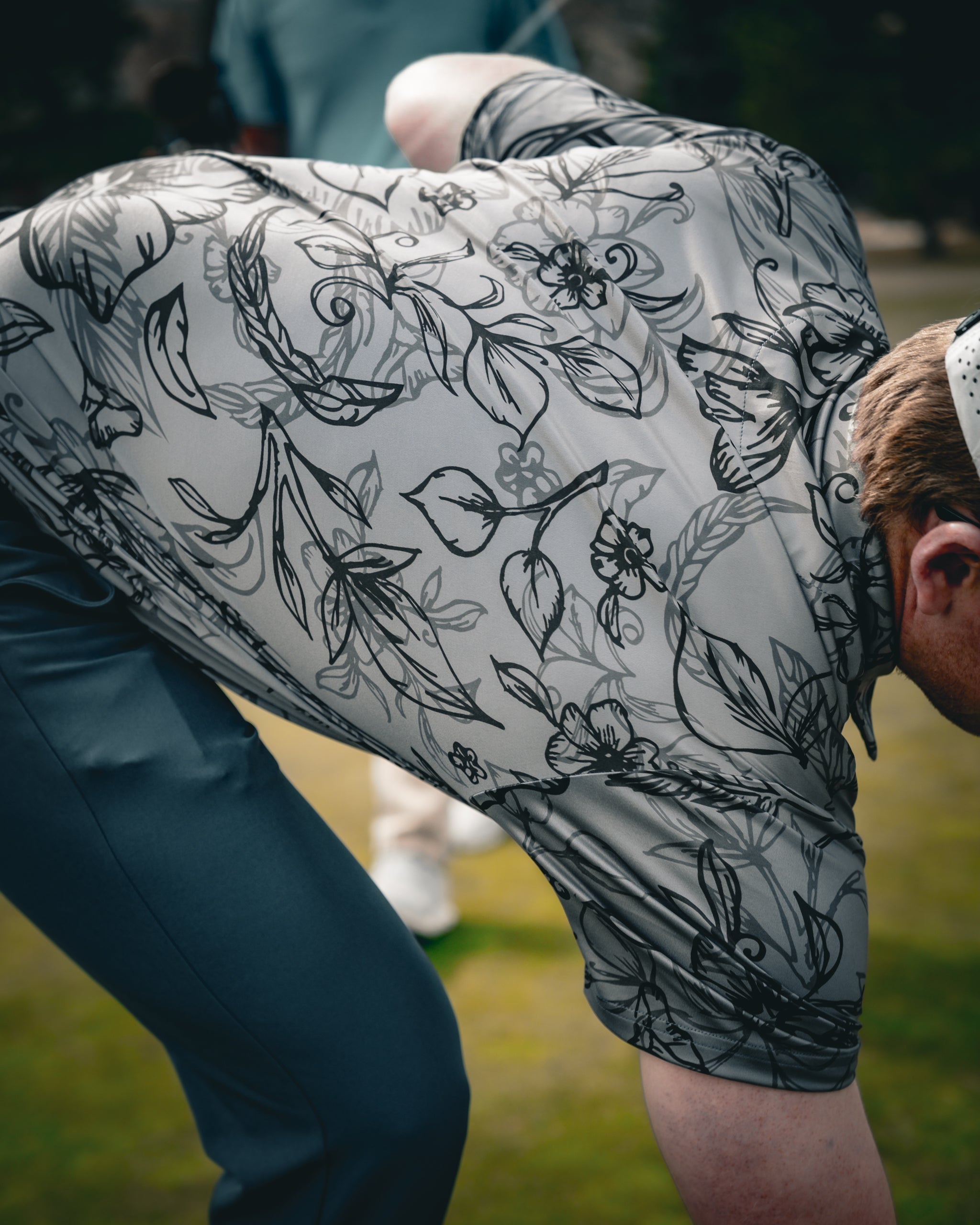 Cabo Midnight: Stylish black and navy striped sweater worn by a model outdoors, showcasing its lightweight fabric and relaxed fit.