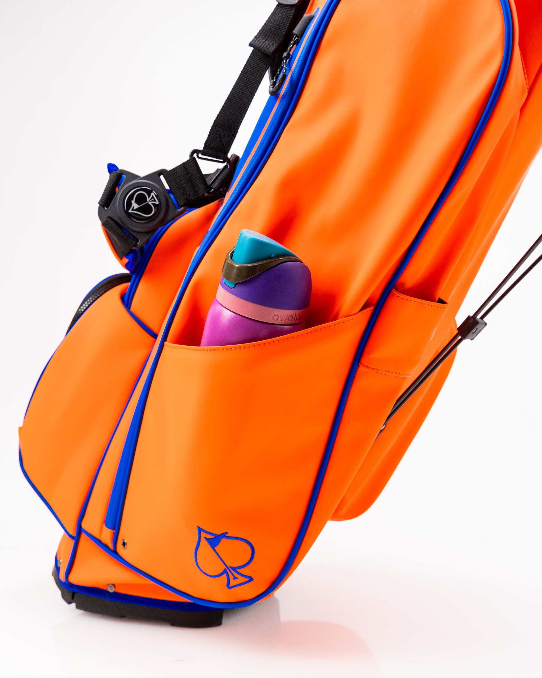 Player Preferred™ Golf Bag in vibrant orange color with multiple pockets and ergonomic straps.