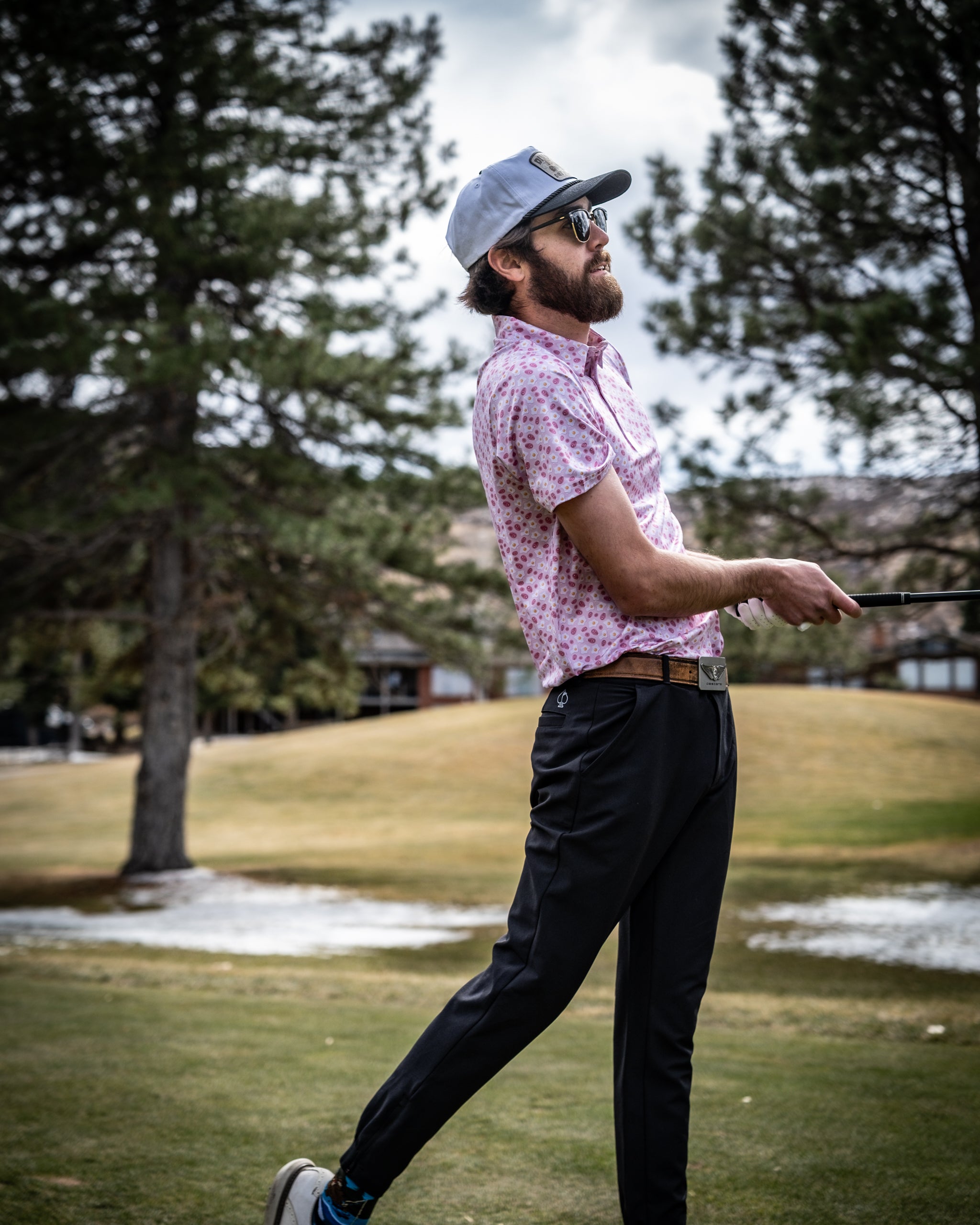 Delicious Ham n' Egg dish served on a wooden table, featuring perfectly cooked eggs and slices of ham, garnished with fresh herbs.