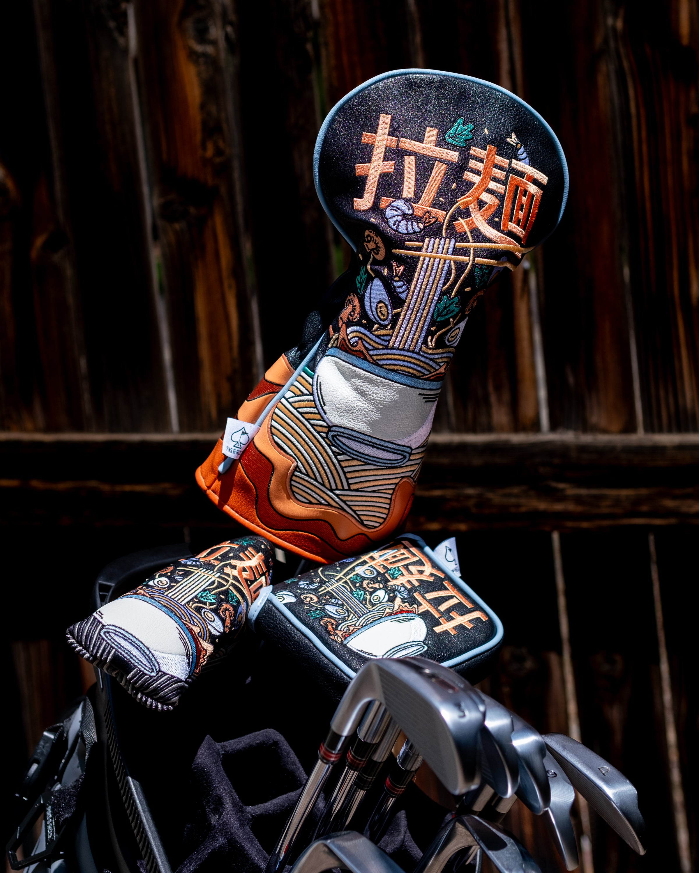 Golf driver headcover featuring a colorful ramen bowl design with chopsticks, noodles, and Japanese characters.