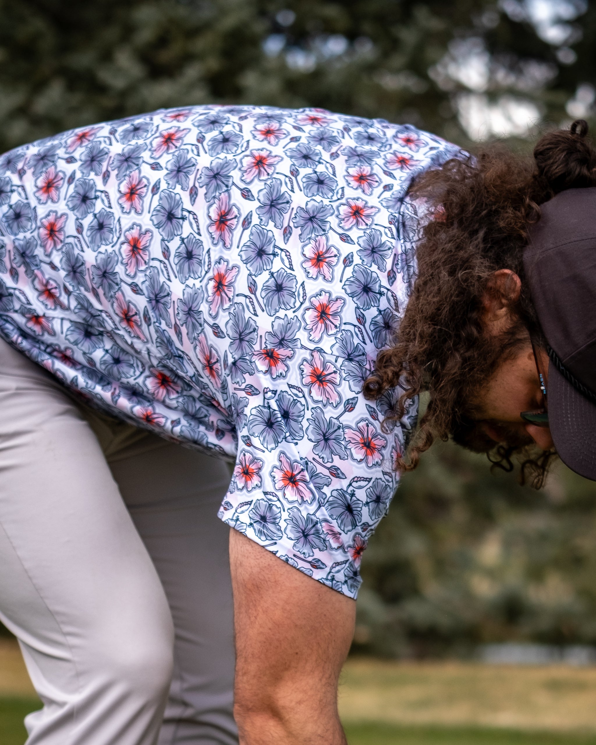 Hibiscus Harmony floral arrangement featuring vibrant hibiscus flowers, lush greenery, and elegant styling in a decorative vase.