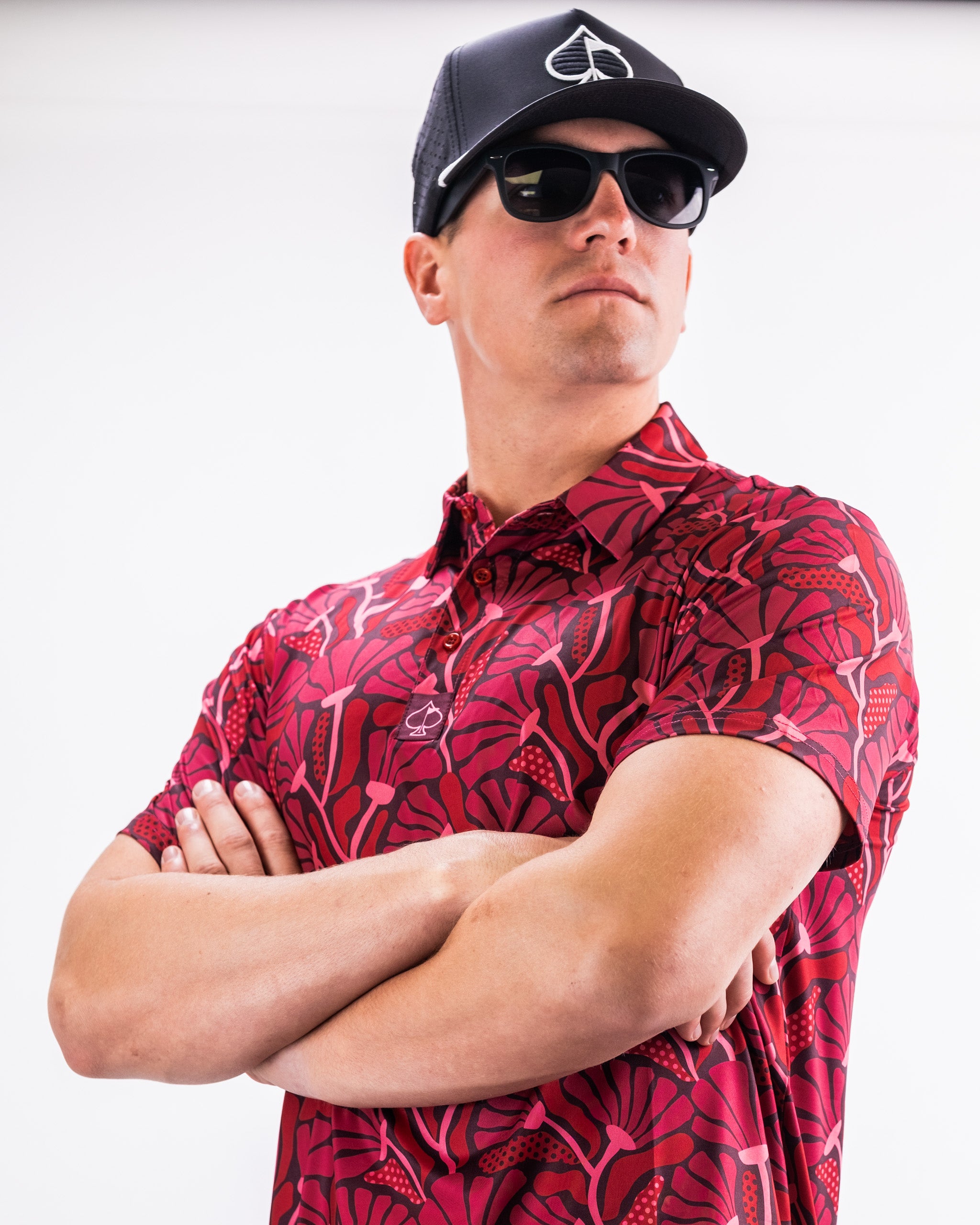 Men's Garden Party shirt featuring a vibrant crimson bloom floral pattern on a light background.