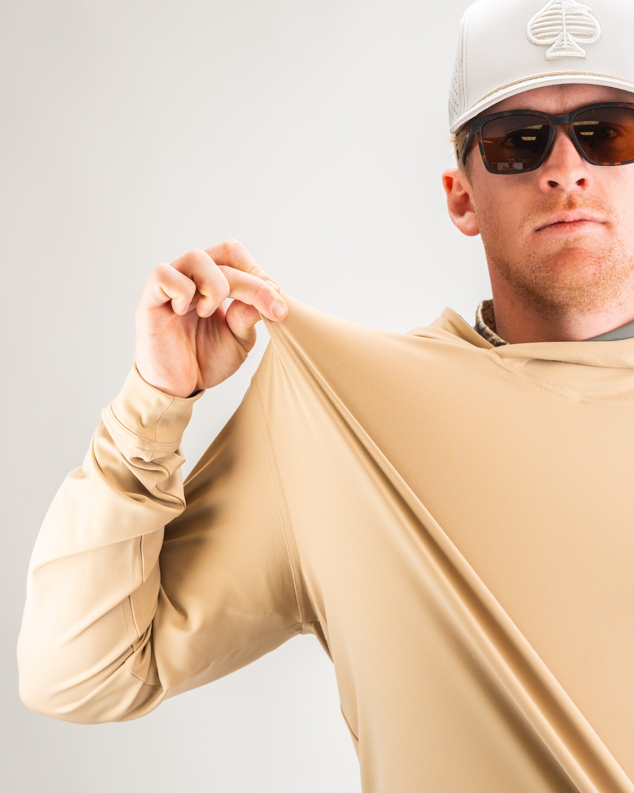 Performance golf hoodie in Big Blind Sand color, featuring a modern design and breathable fabric, perfect for on-course comfort.